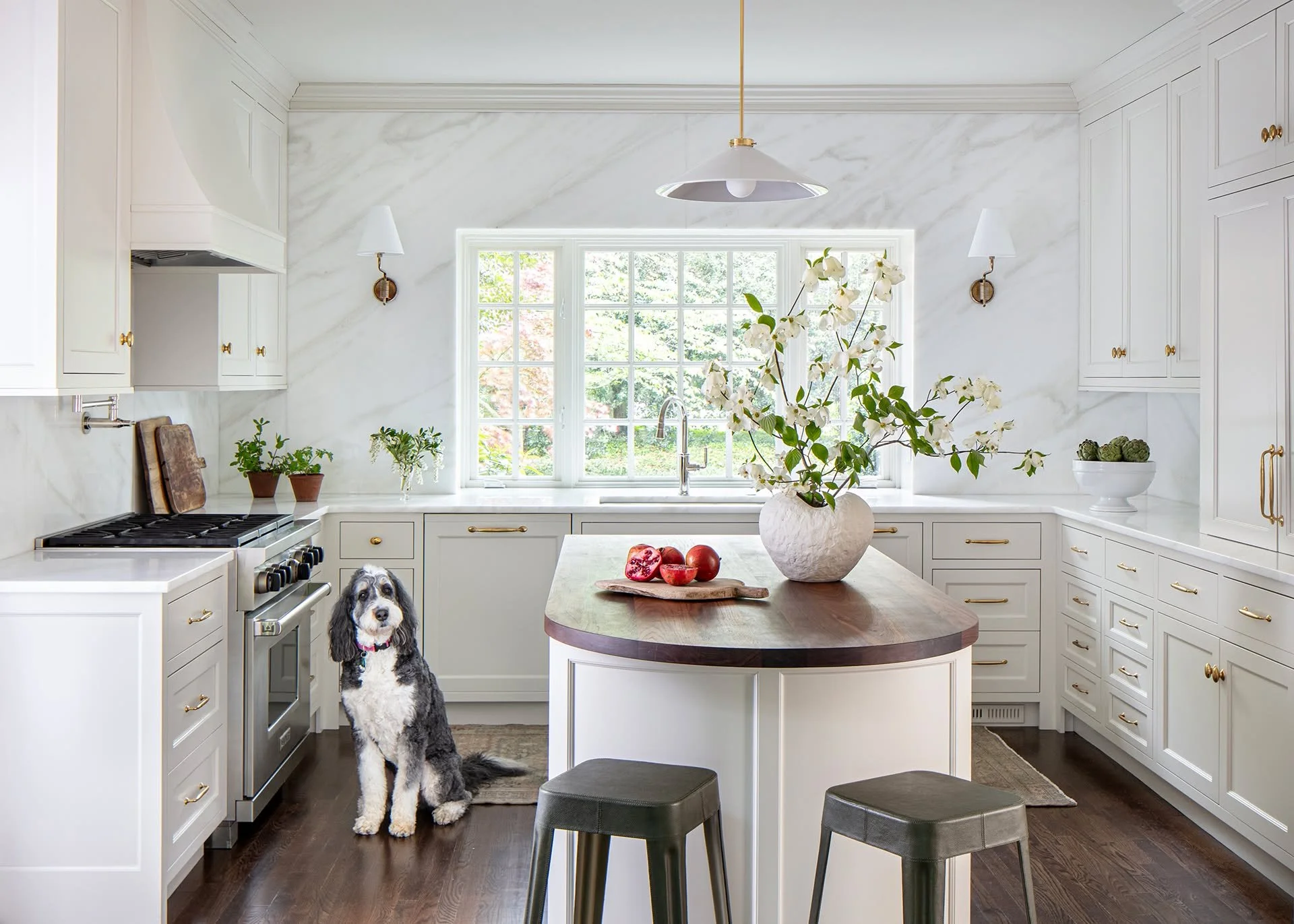 Classic detailing, a crisp palette, and quality materials come together to create a kitchen that feels calm, layered, and timeless.

From the start, this room was about the windows. We designed the cabinetry to play a supporting role&mdash;elegant in