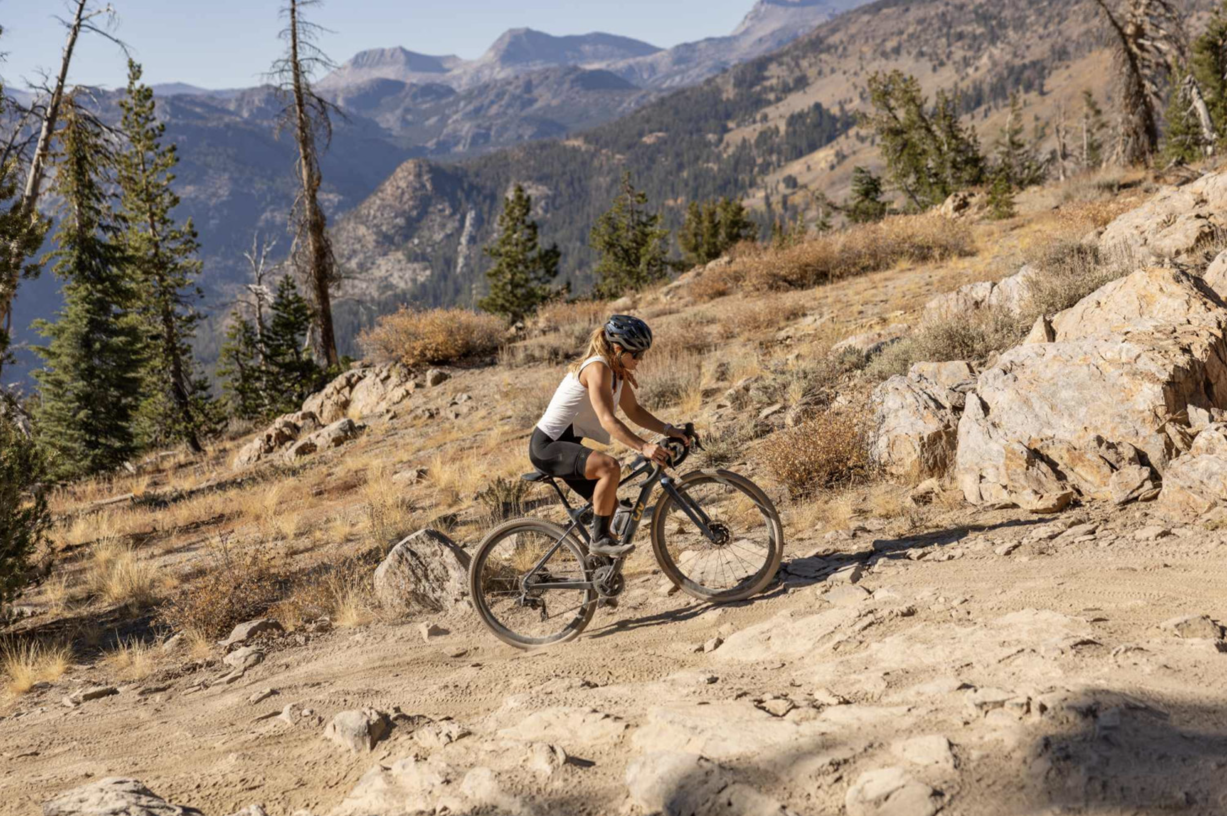 Niki (woman) riding in the mountains on a gravel bike