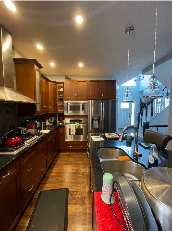 Before photo of outdated Calgary kitchen with dark cabinets and traditional finishes – Terra Villa Developments