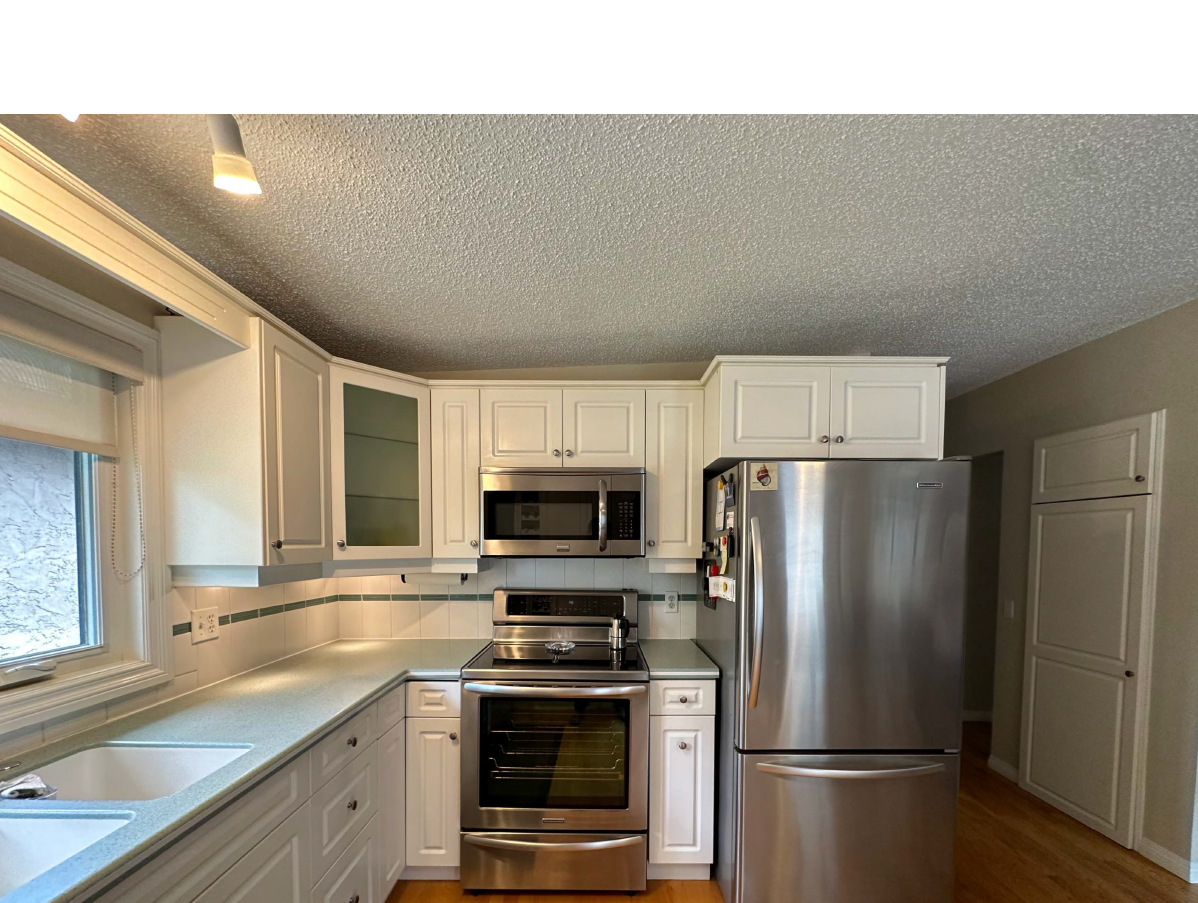 Calgary Renovation Contractor Dalhousie kitchen before renovation with outdated oak cabinetry and dark finishes