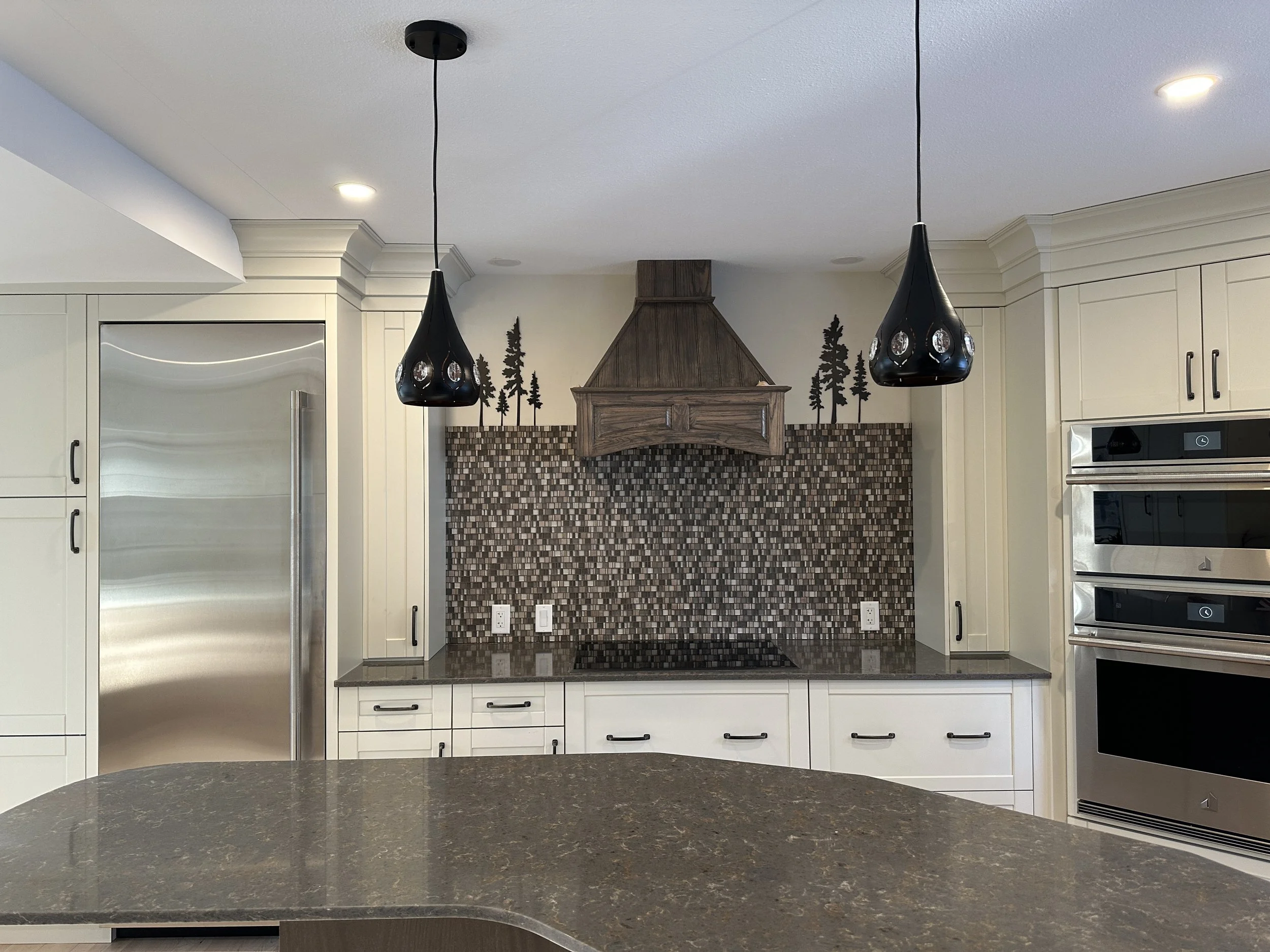 After Canmore kitchen renovation with custom cabinetry, modern lighting, and luxury finishes