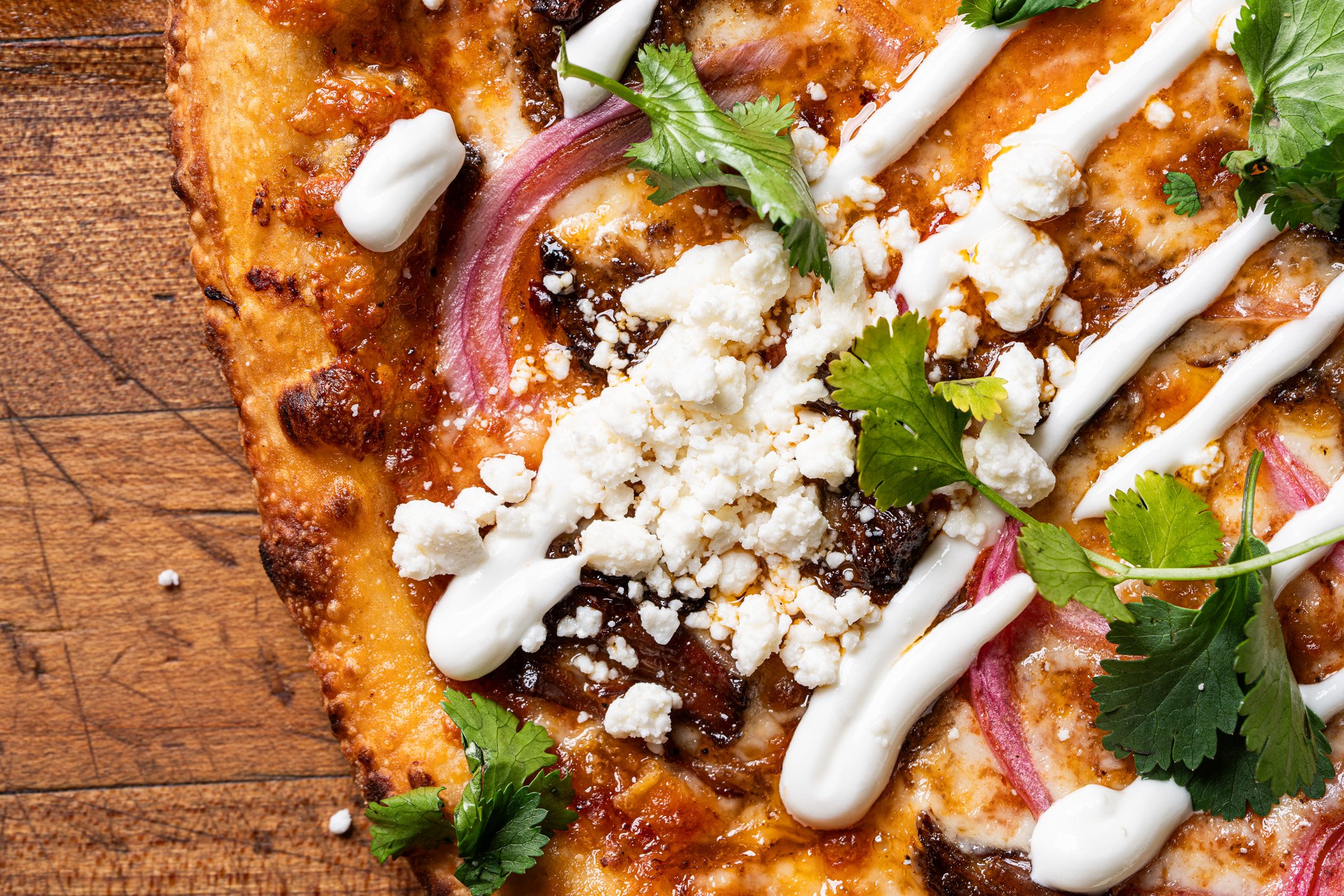 detailed view of the crust and delicious toppings on the LA Taco pizza