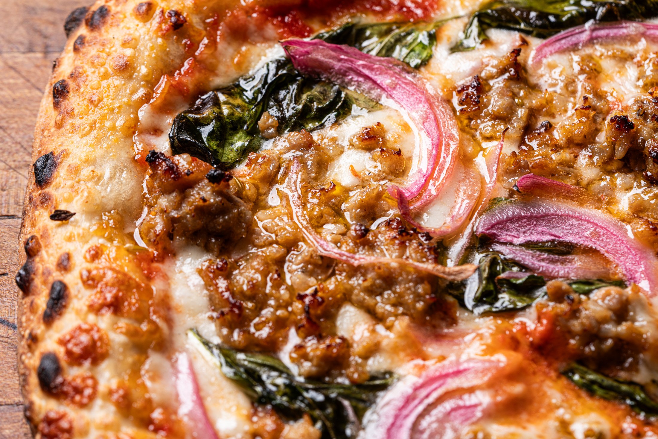Fresh basil, cheese, pickled red onion and Italian sausage on naturally leavened sourdough crust