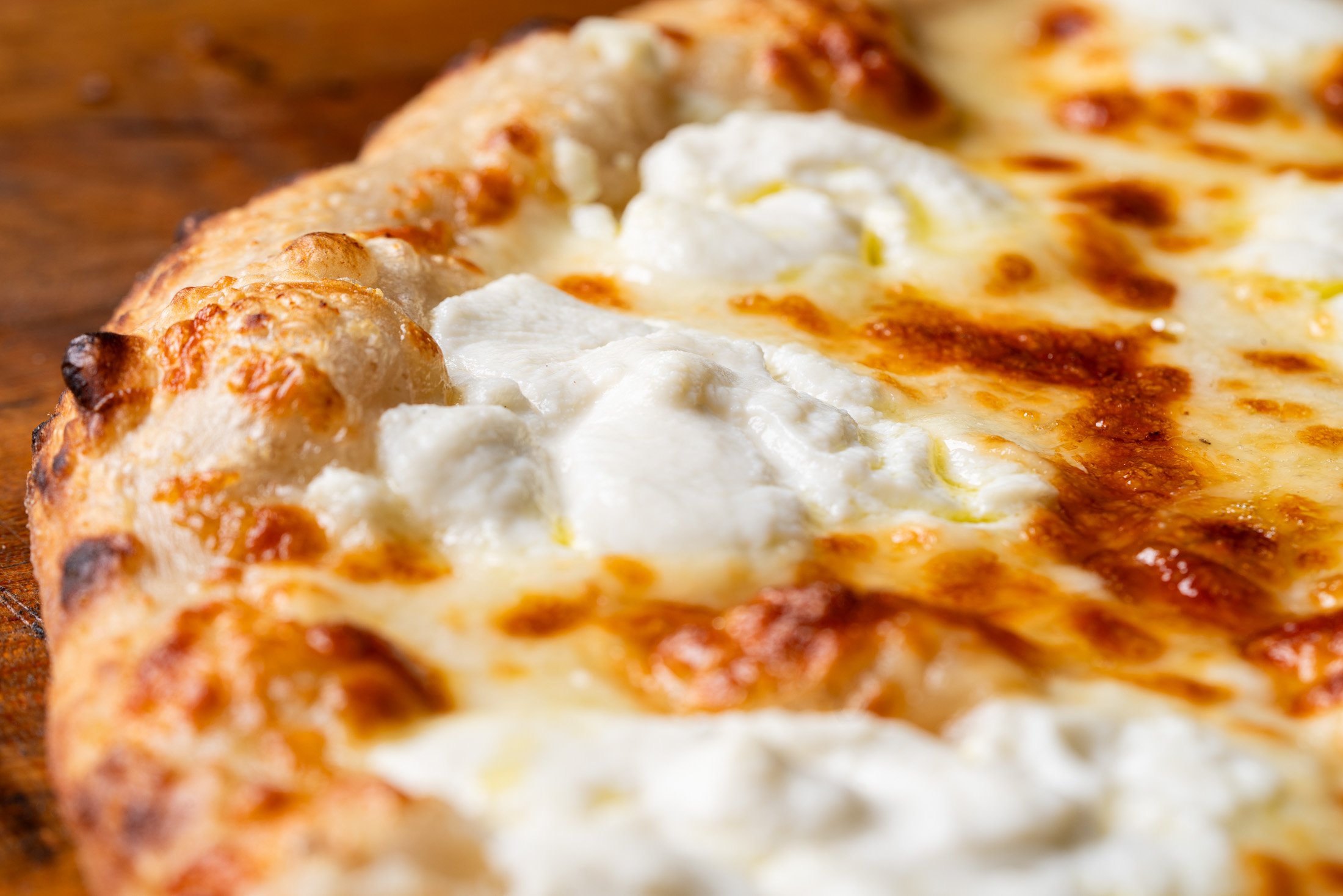 Detail view of crust, and cheese