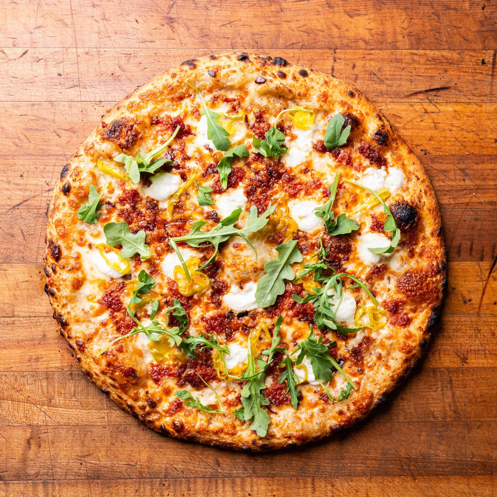 The Notorious P.I.G. special featuring ground pepperoni, ricotta, peperoncini and arugula.