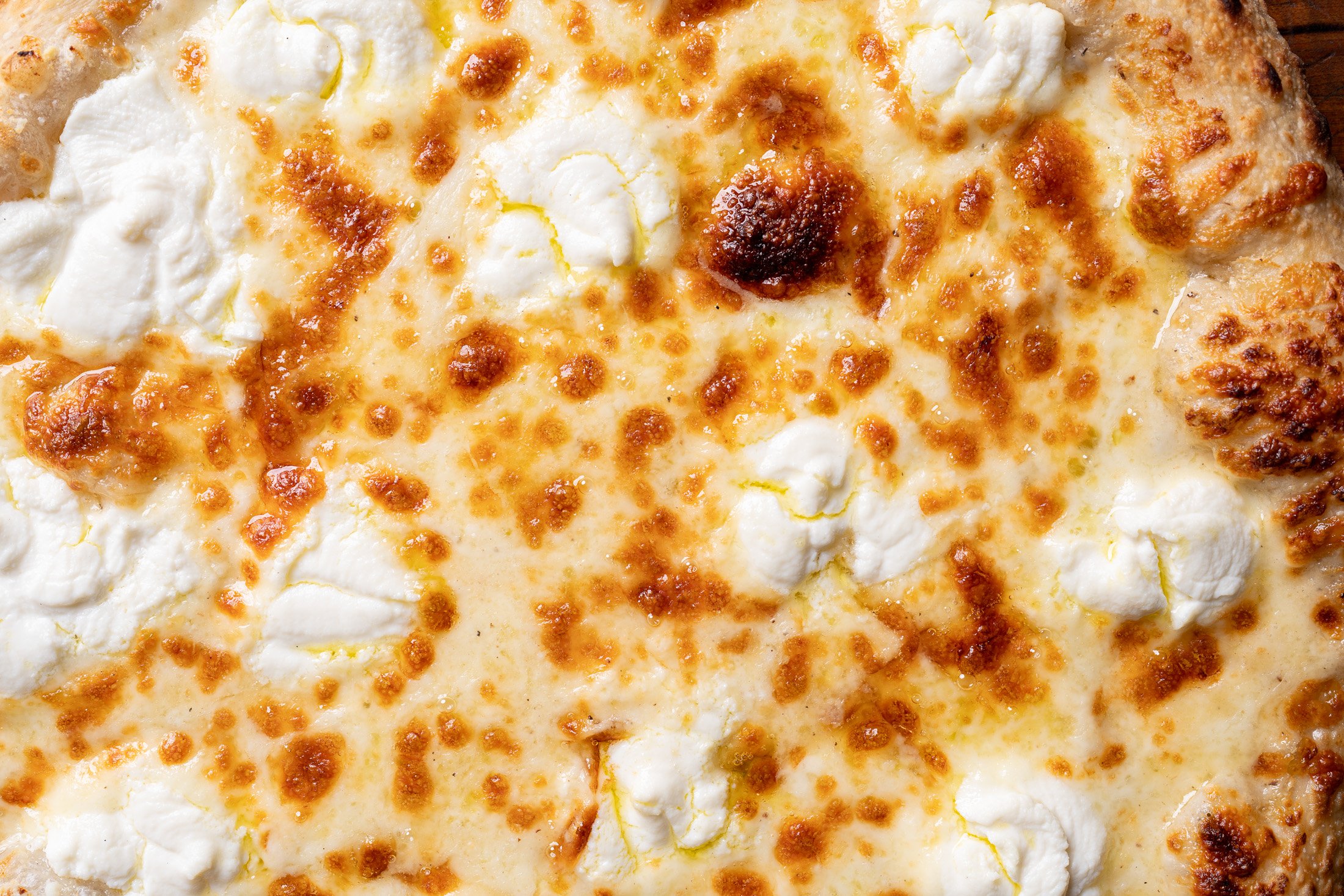 close up view showing mozzarella, ricotta, and olive oil
