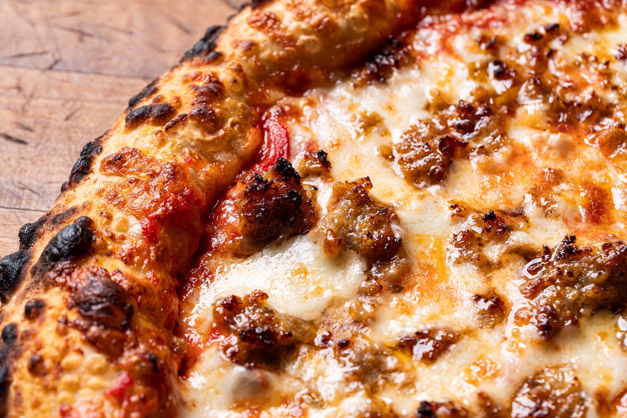 detail view of sausage, cheese, and crust
