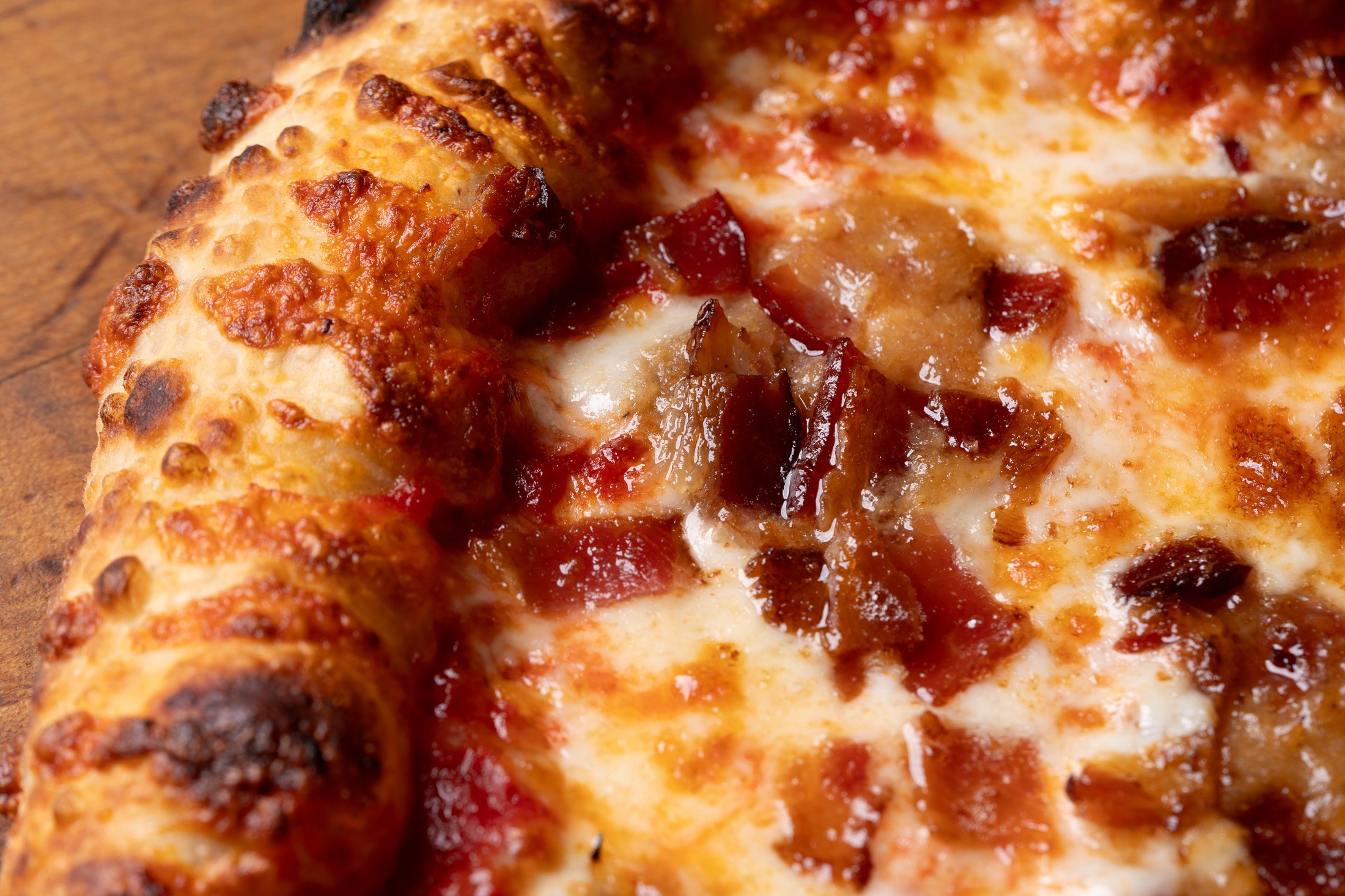 close up view of the Bacon Jamming pizza crust and toppings