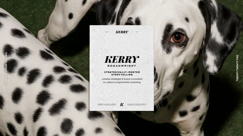 A Dalmatian dog lying on grass with a white business card on its side. The business card has the name 'Kerry' and the title 'strategically-rooted storytelling.'