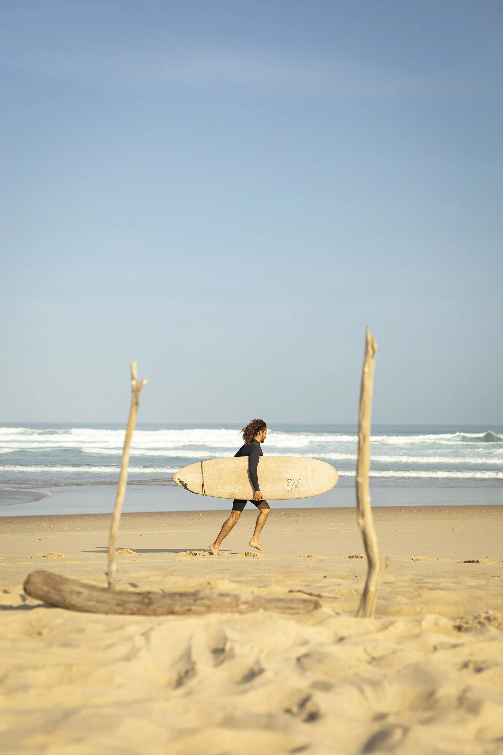 Walking surfer on the beach