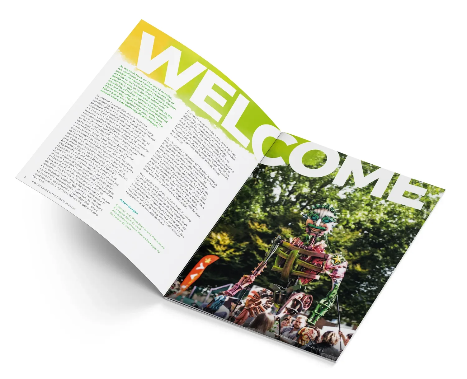 Open magazine with large green and white 'WELCOME' headline on the left page and colorful dragon float parade photo on the right page.