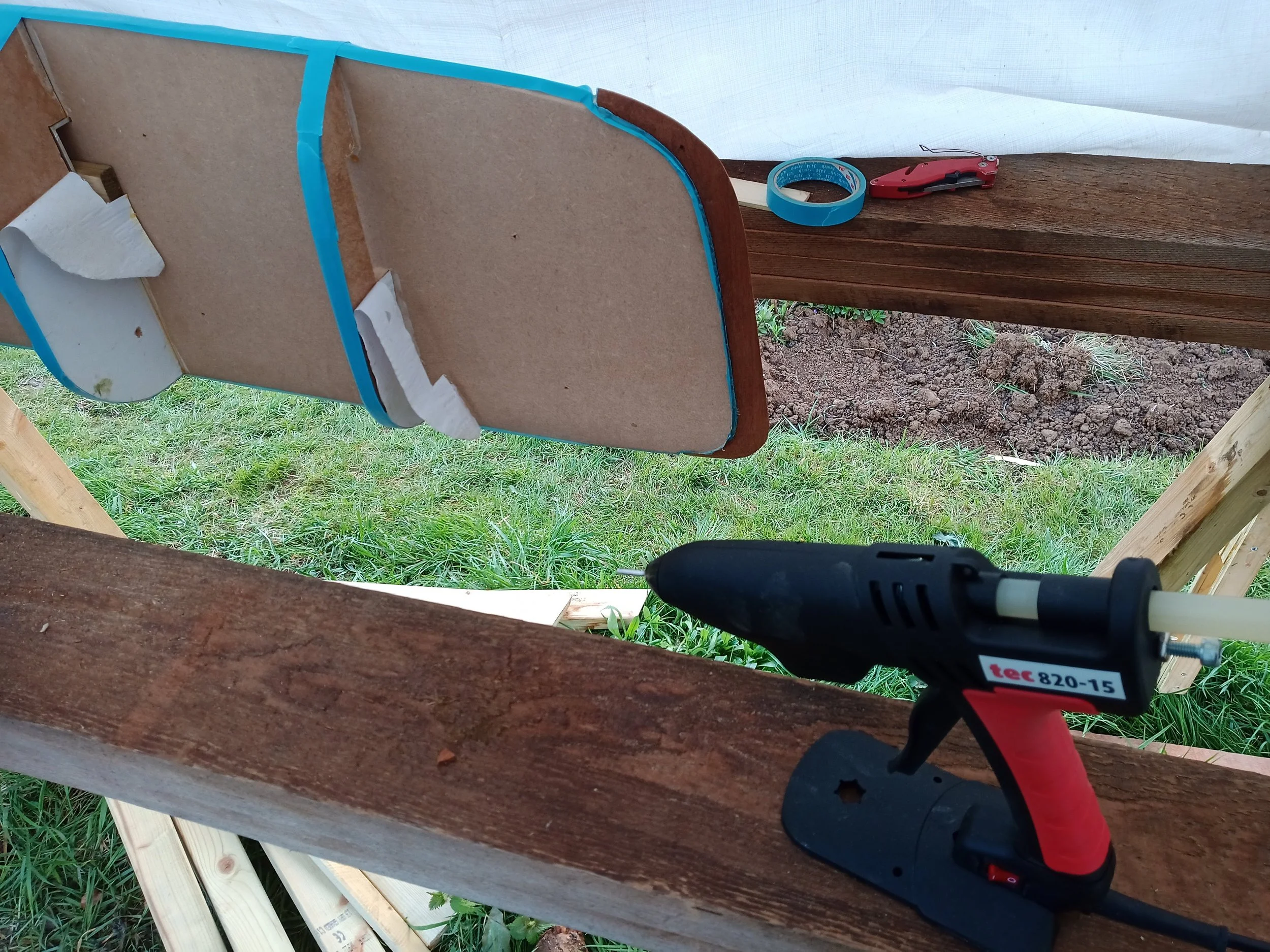 Inner stem and stern attached to the bow and stern forms. Hot glue on masking tape. This fancy hot glue gun heats up in no time and was absolutely game-changing on this project.
