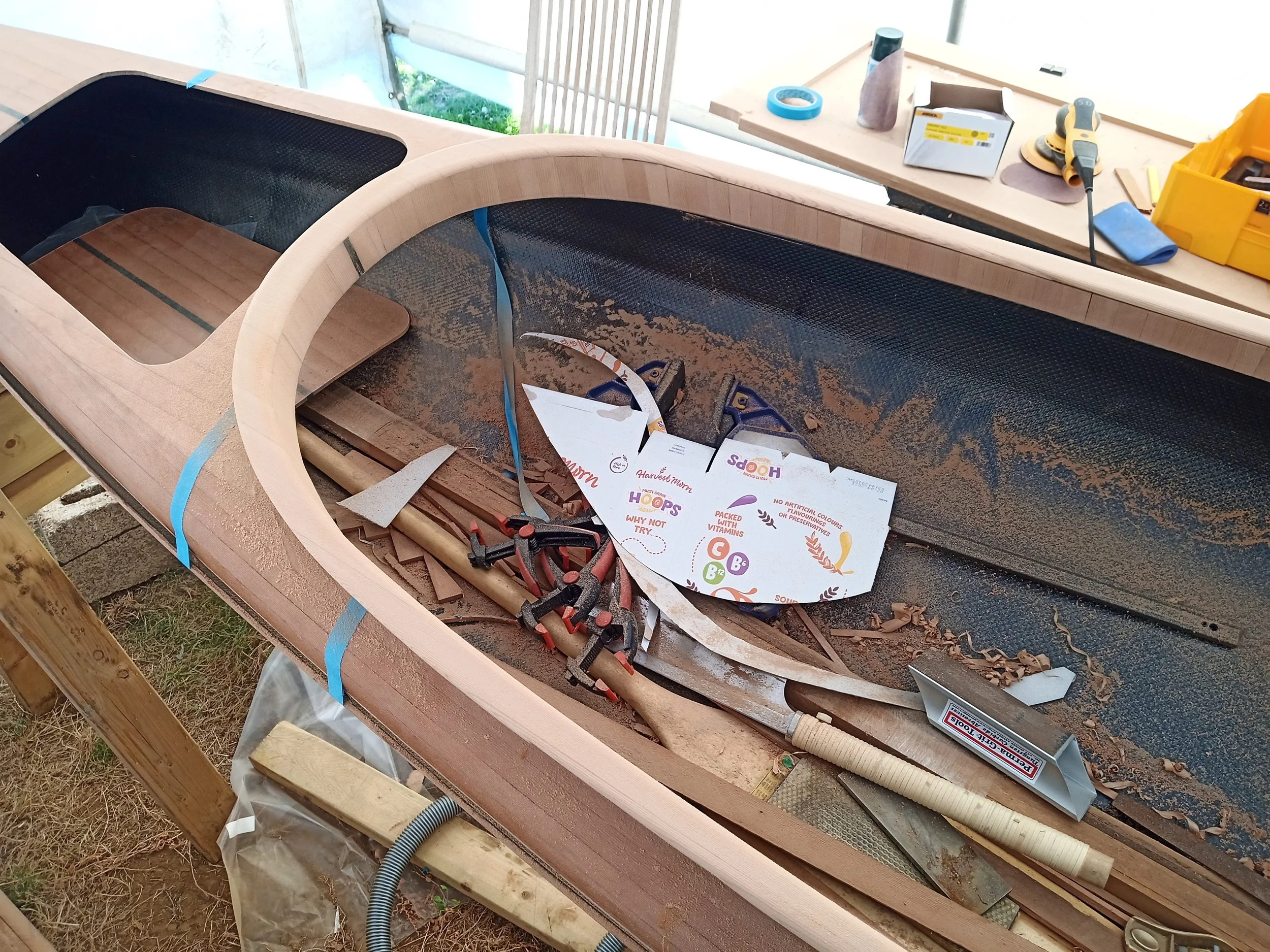 Accumulated sawdust and scraps in the bottom of the hull. Notice that the rear hatch is now cut out.
