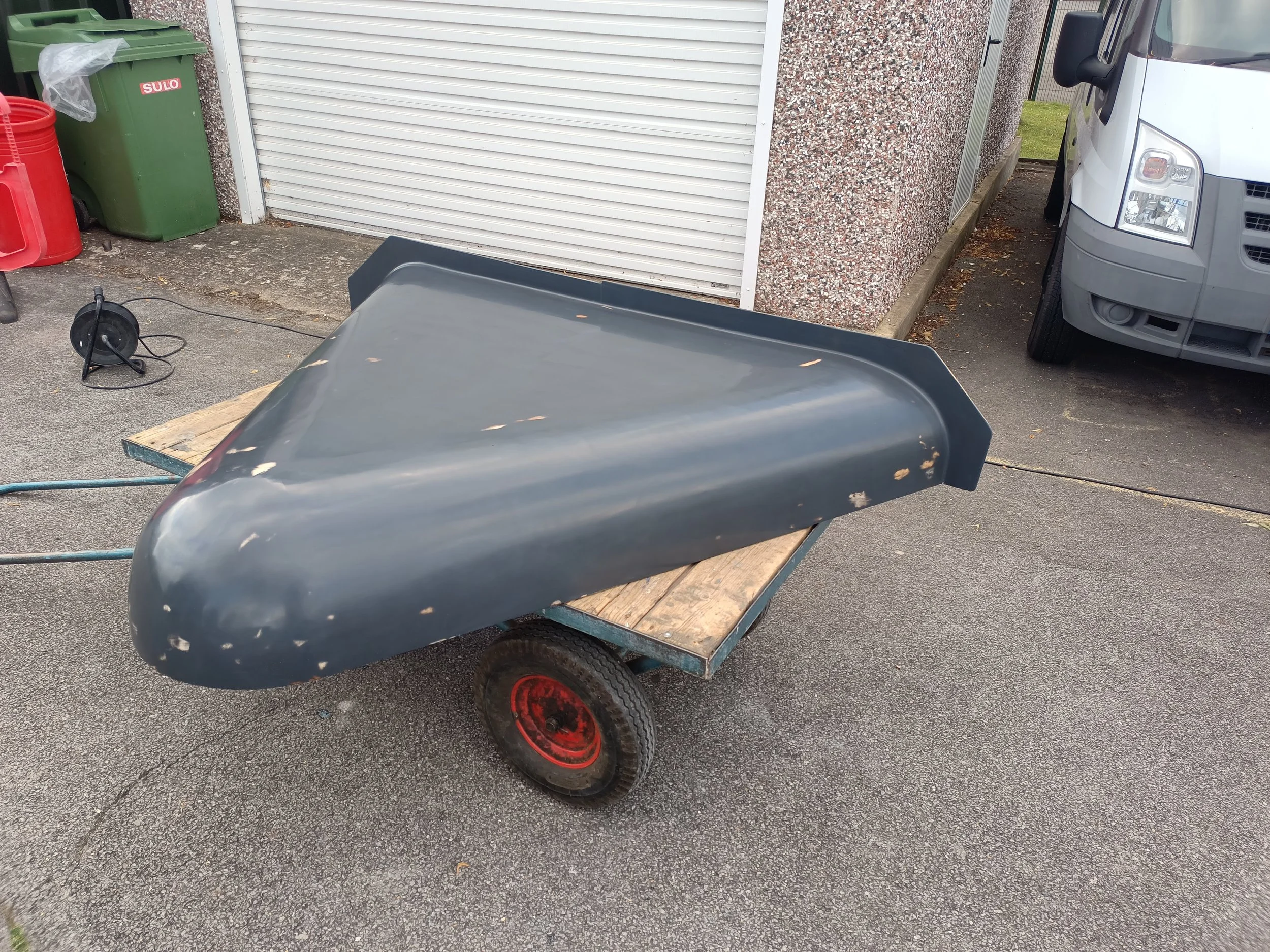 A fully primed and waxed bonnet mould, also fitted with a flange along the rear edge.