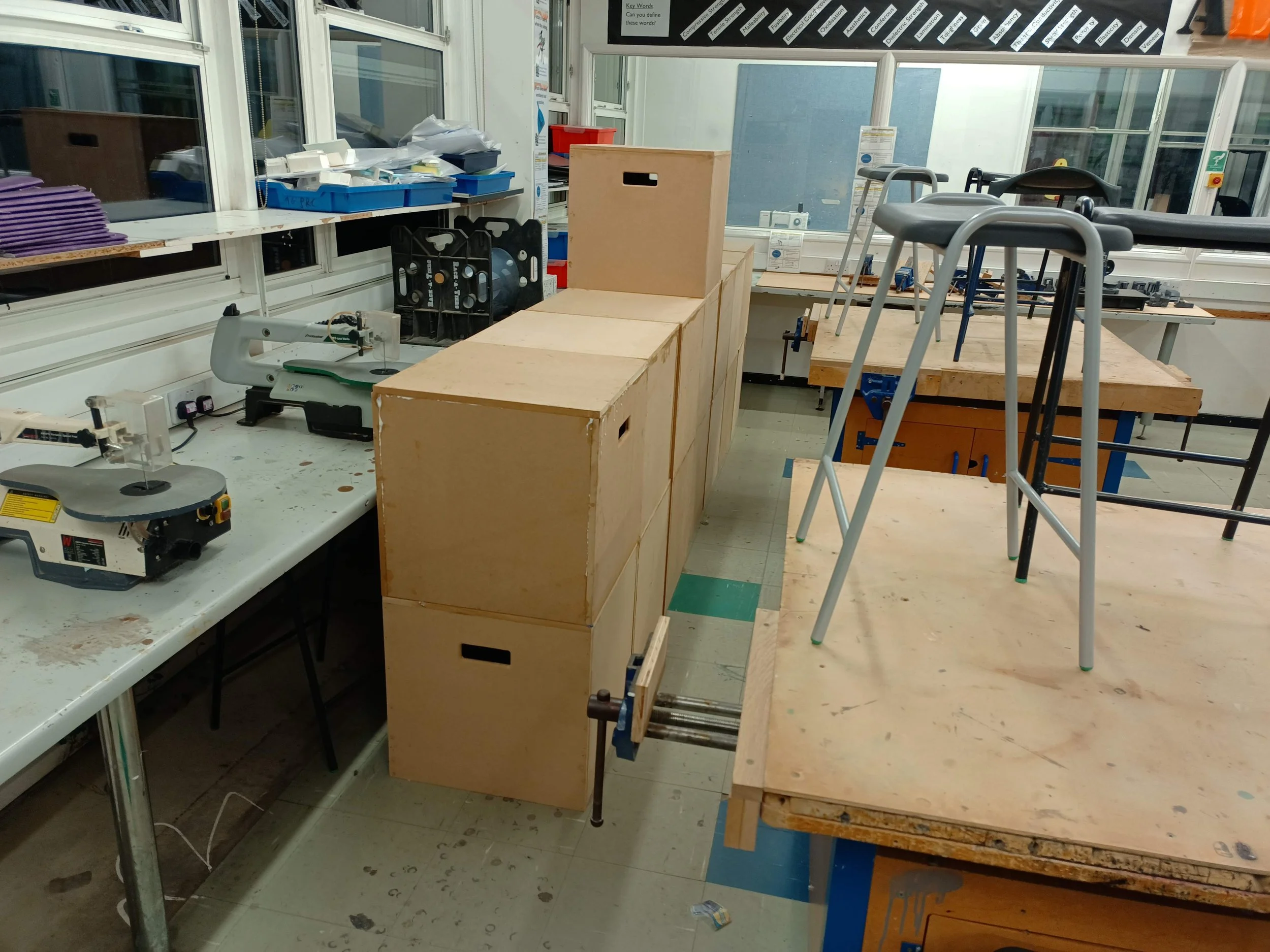 Some stage blocks built for (and with) Drama. I designed a kit of panels, including a router jig for the handle slots, to enable batch production of these boxes.