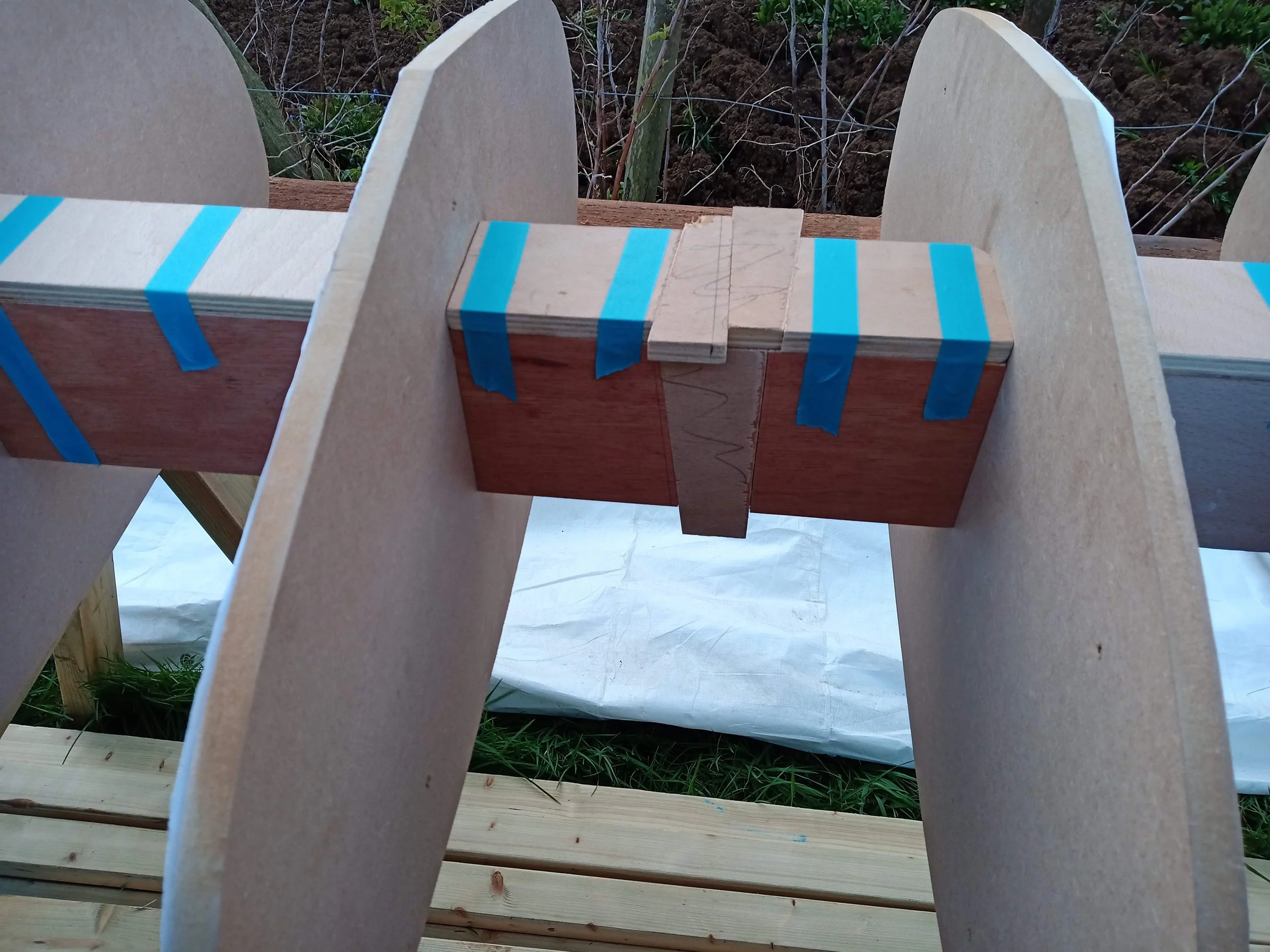 The central spacer was split in two and plywood wedges were used to apply compression to the whole stack.