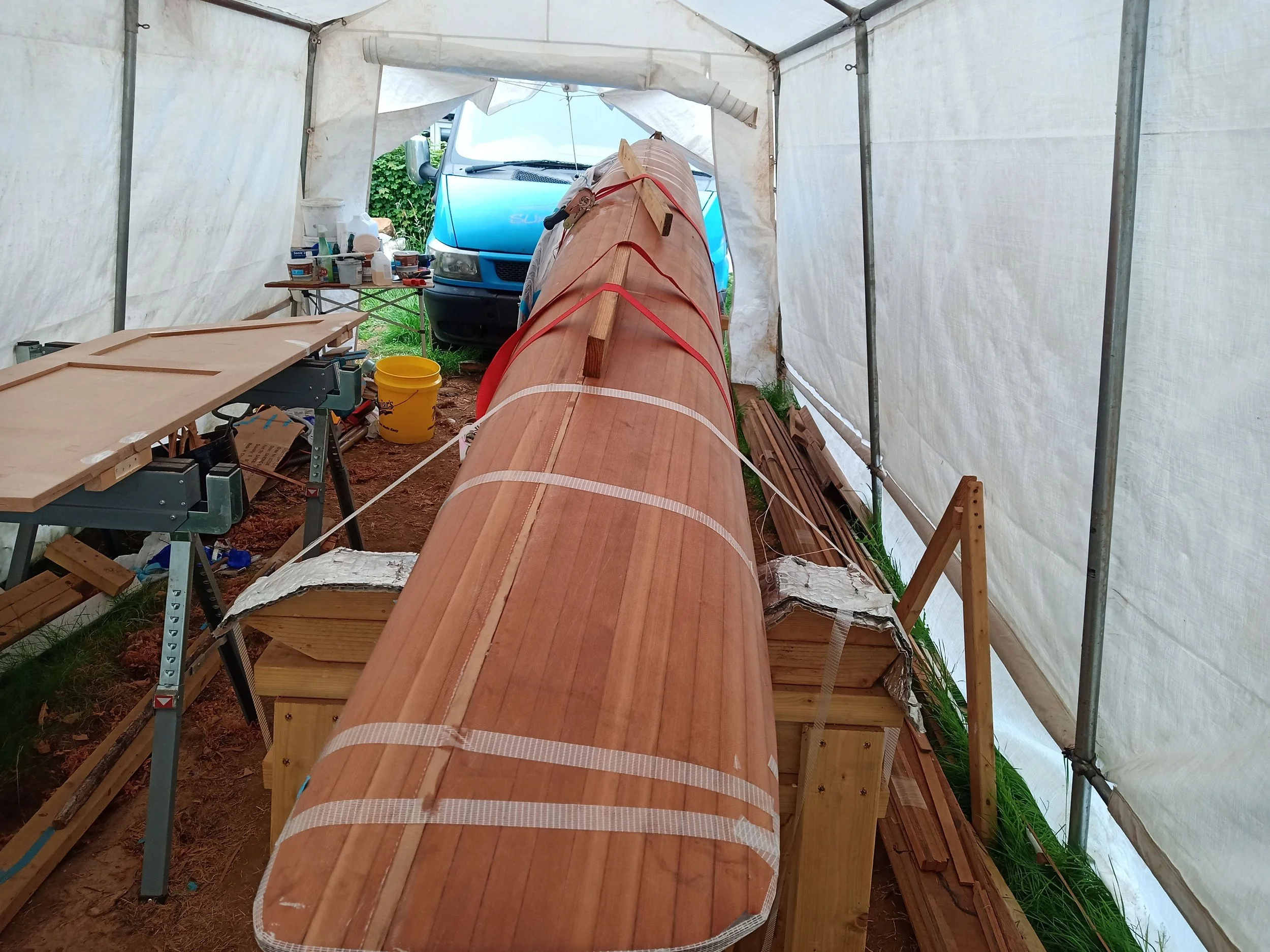 A combination of tape and ratchet straps helped to hold the boat on its side and with proper deck-hull alignment while the interior joints were taped.