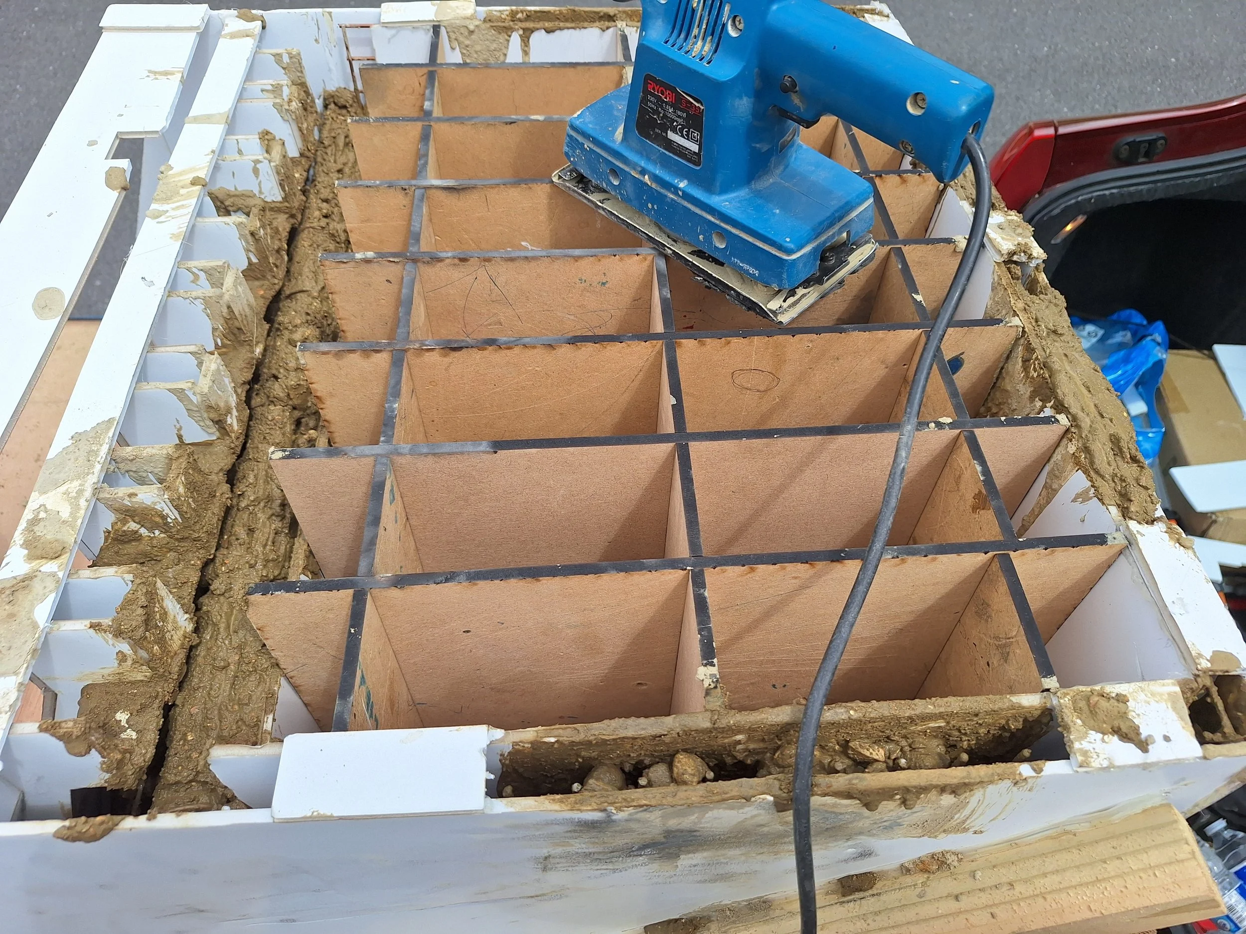 This MDF grid structure slotted together inside the tank to support the foam board mould.
