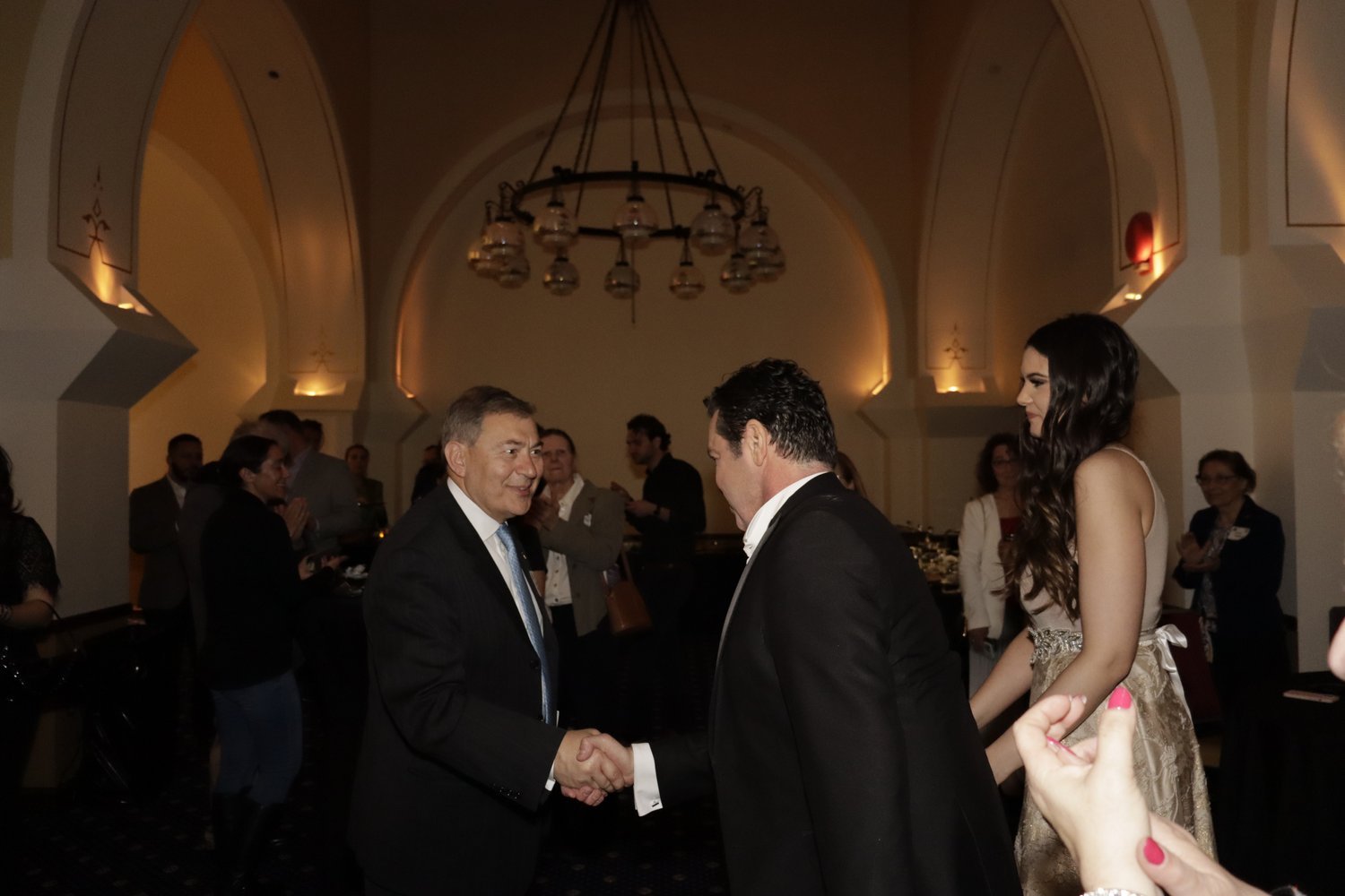  AHI Board Member George Tsetsekos greets Mario Frangoulis at the afterparty. 