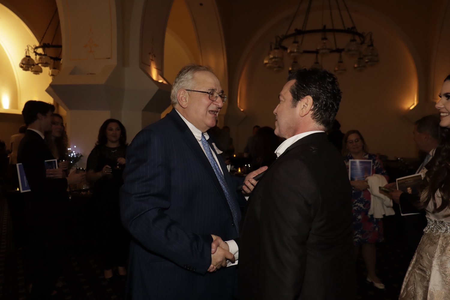  NHS Executive Director Art Dimopoulos speaking with Mario Frangoulis at the concert afterparty. 