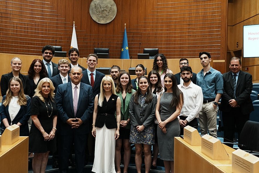 President of the House of Representatives, Annita Demetriou (center) with AHI President Nick Larigakis (to her right), and Maria Wills, AHI Board Member (to his right) with the students at the House of Representatives of the Republic of Cyprus.