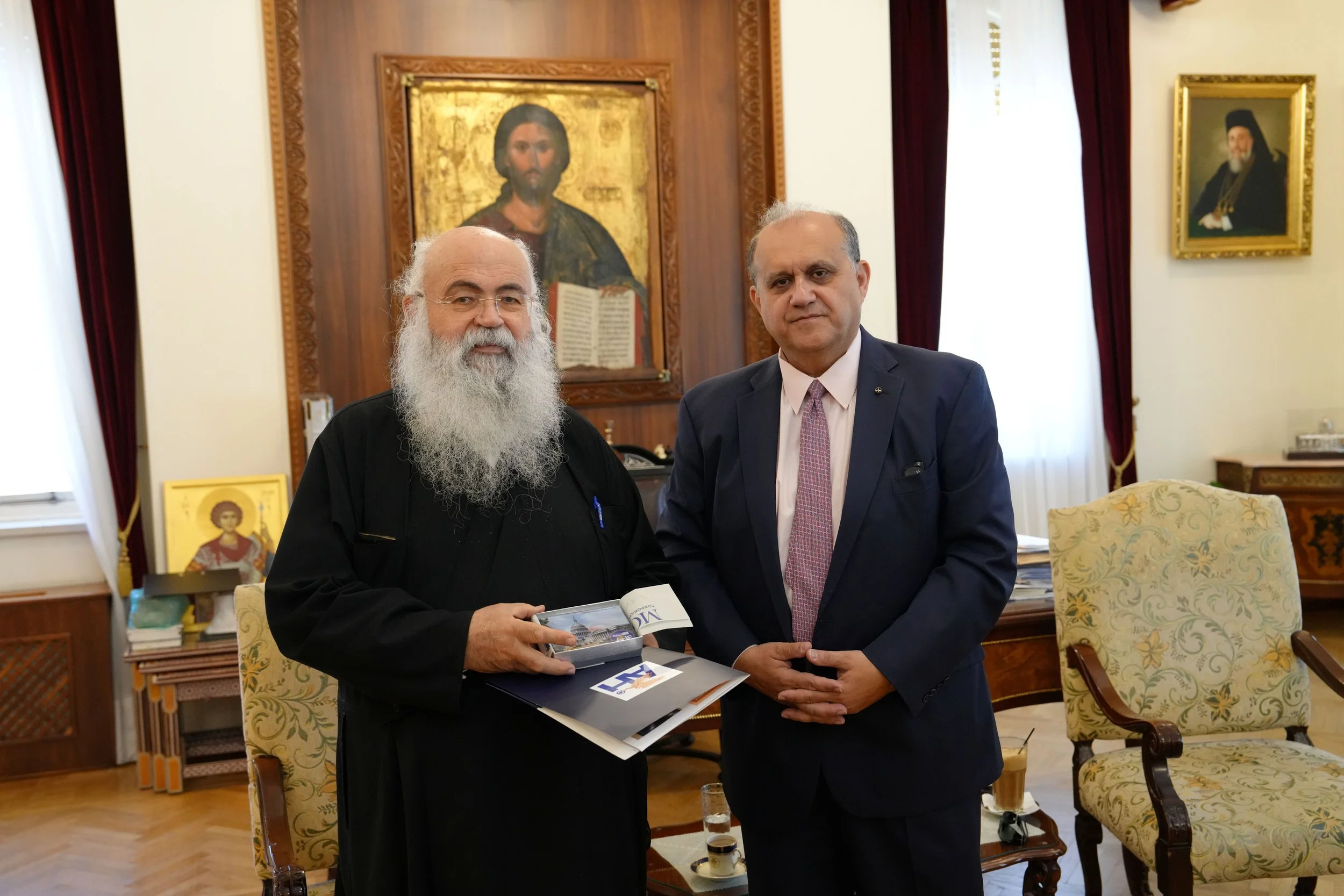  Nick Larigakis presenting a commemorative gift to His Beatitude Archbishop of Cyprus Georgios. 