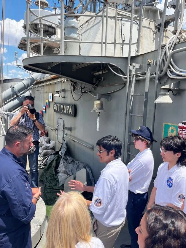  AHIF participant Demetrios Lahiri asking a question during the tour of the frigate HS Hydra. 