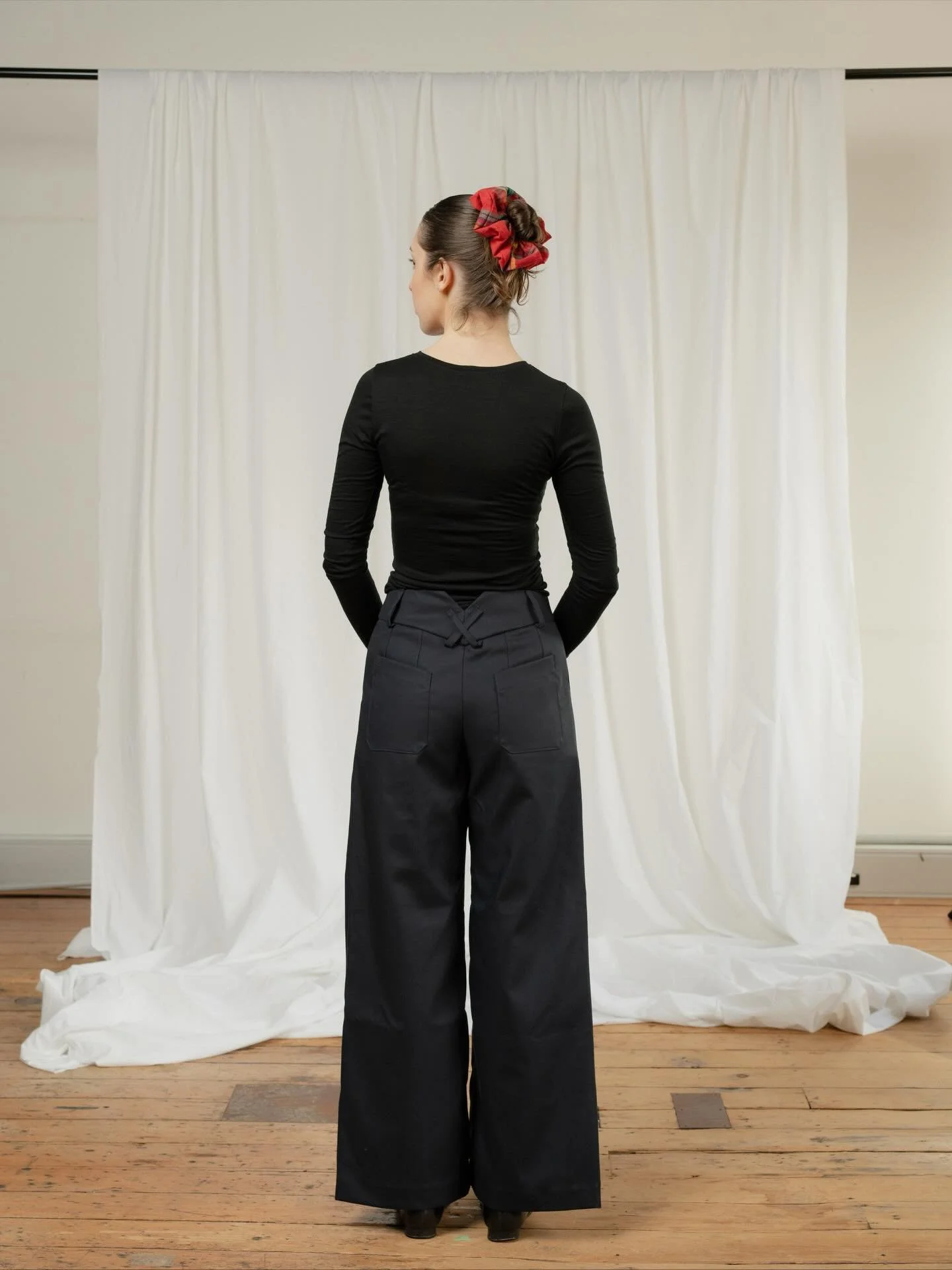 Audition pant 2! Somewhere between a dress pant and pair of jeans, the Audition Pants are a wardrobe staple. They sit just below the belly button and have a full length, wide leg. Featuring front and back pockets, zip fly, front pleats and exaggerate