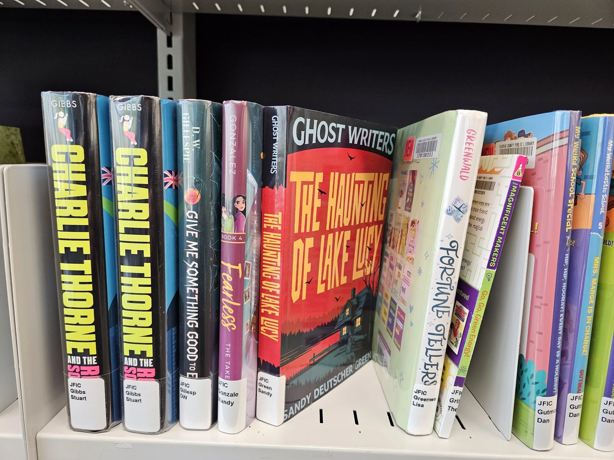 GHOST WRITERS: THE HAUNTING OF LAKE LUCY book is on the Burke Center Library shelf with other middle grade books