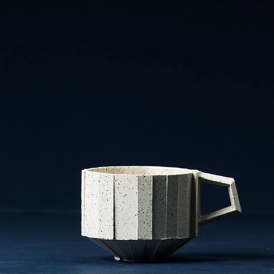Handmade brutalist faceted ceramic cup in speckled white stoneware, by Lea & Nicolas