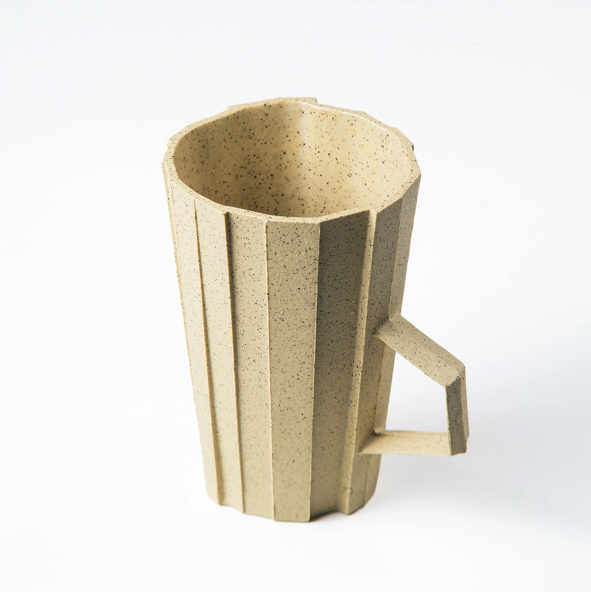 Handmade brutalist faceted ceramic cup in speckled yellow stoneware, by Lea & Nicolas