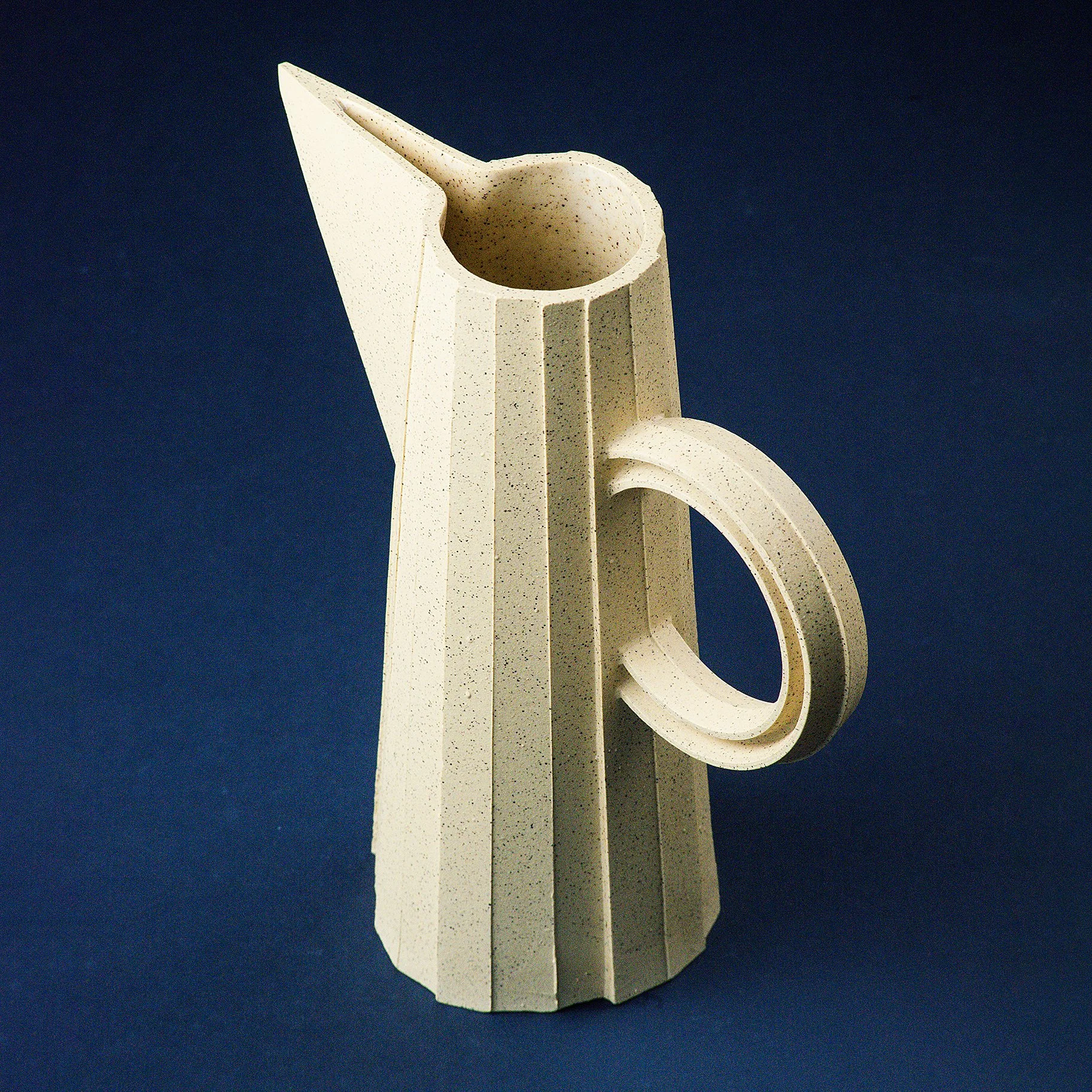 Handmade brutalist faceted ceramic pitcher in speckled yellow stoneware, by Lea & Nicolas