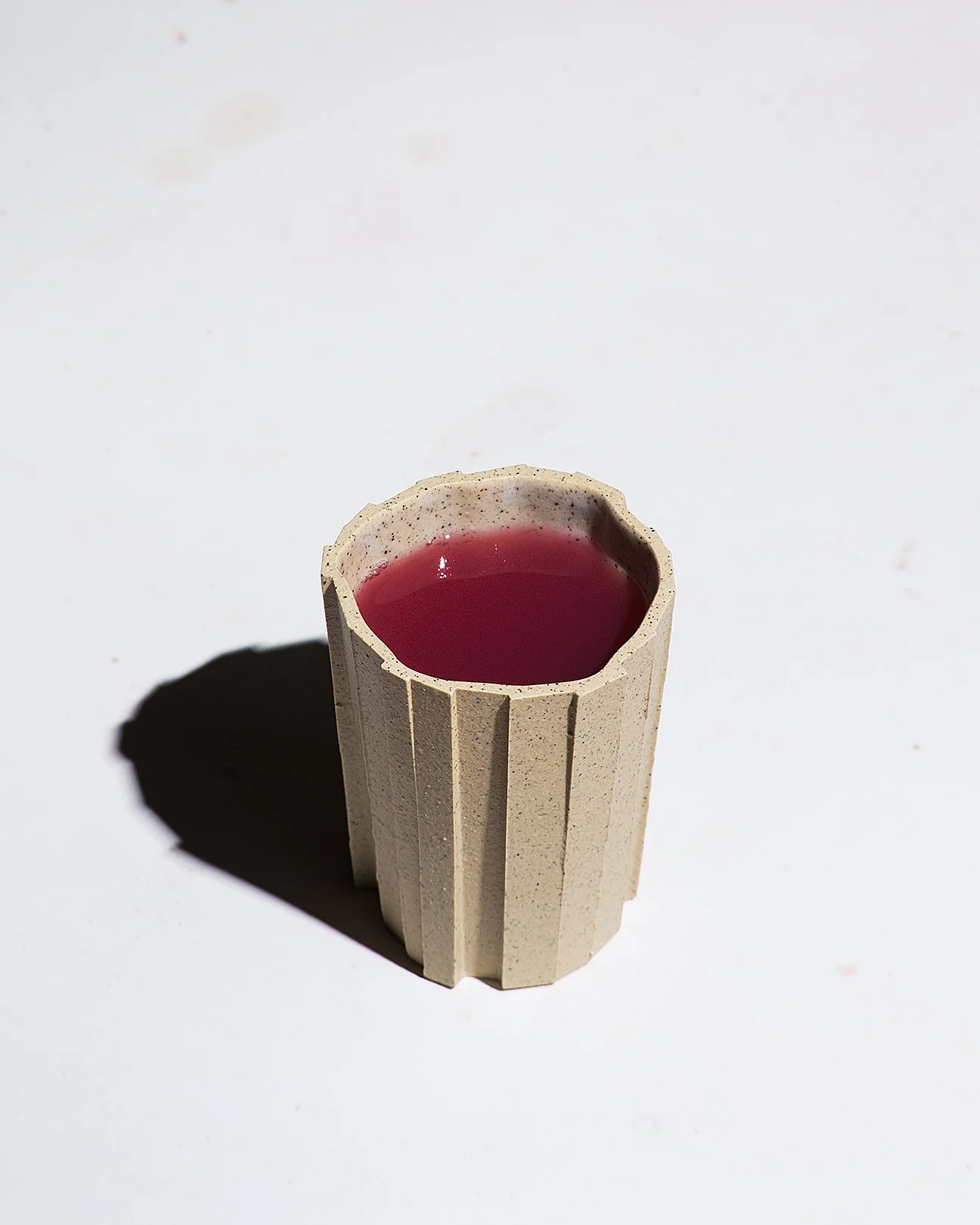 Brutalist handmade faceted ceramic tumbler in speckled buff stoneware, by Lea & Nicolas