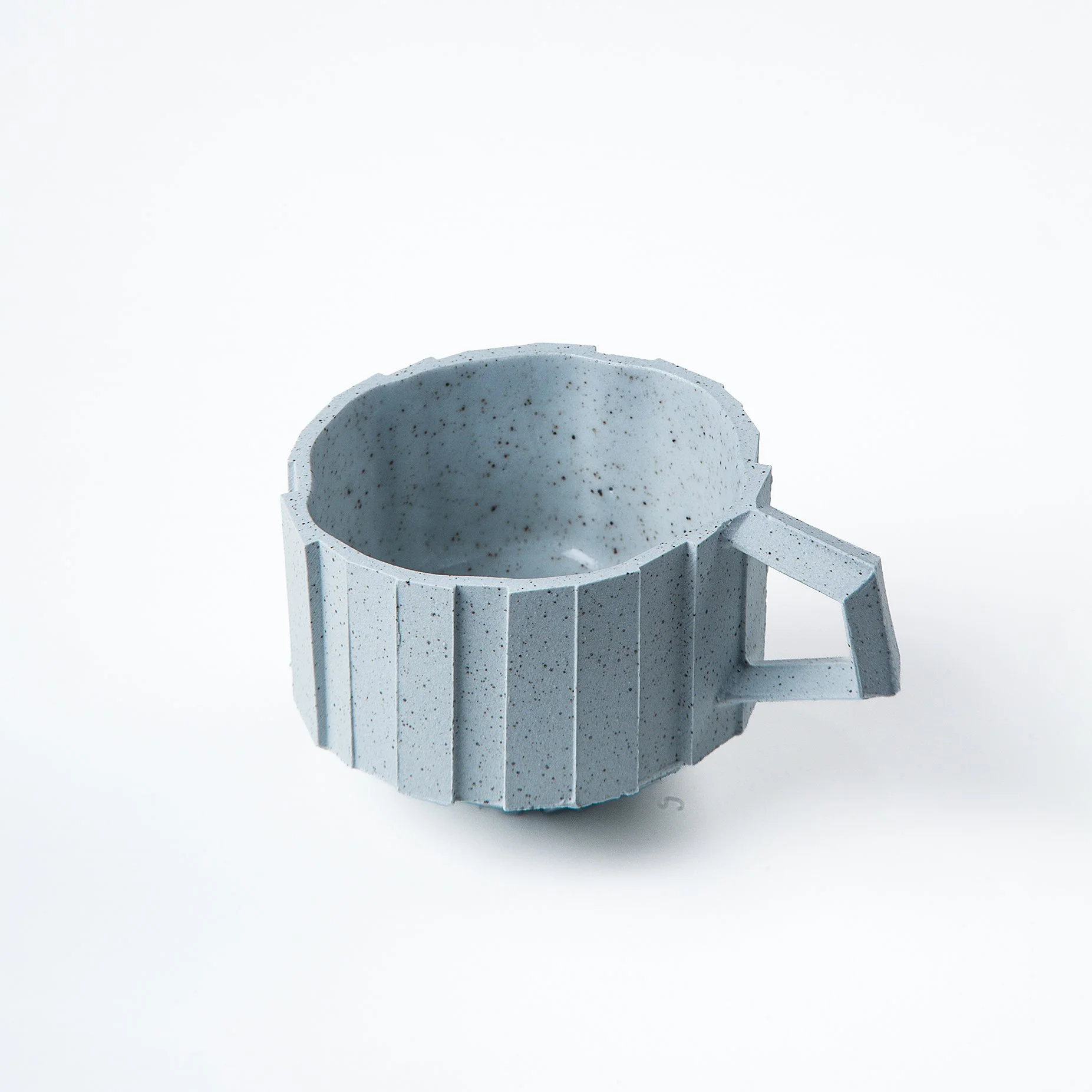 Handmade brutalist faceted ceramic cup in speckled blue stoneware, by Lea & Nicolas