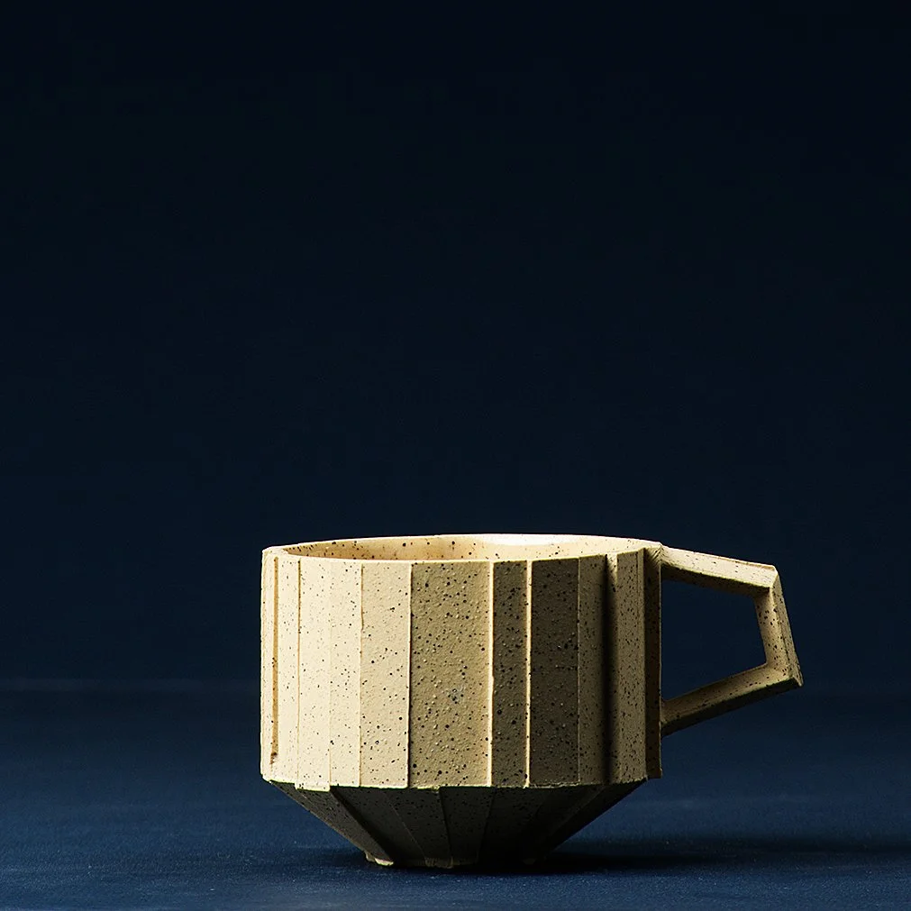 Handmade brutalist faceted ceramic cup in speckled yellow stoneware, by Lea & Nicolas
