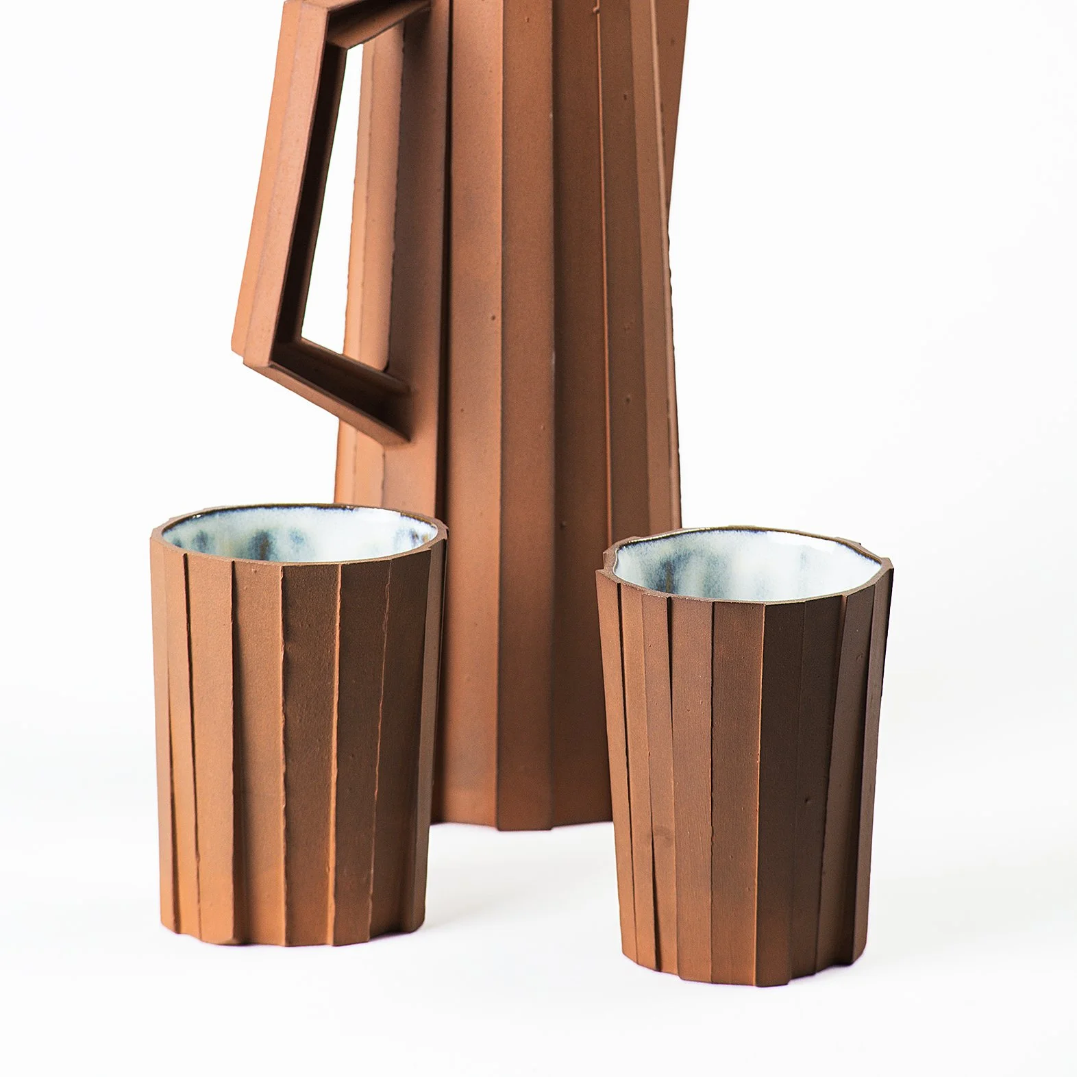 Handmade brutalist faceted ceramic tumbler, and pitcher by Lea & Nicolas