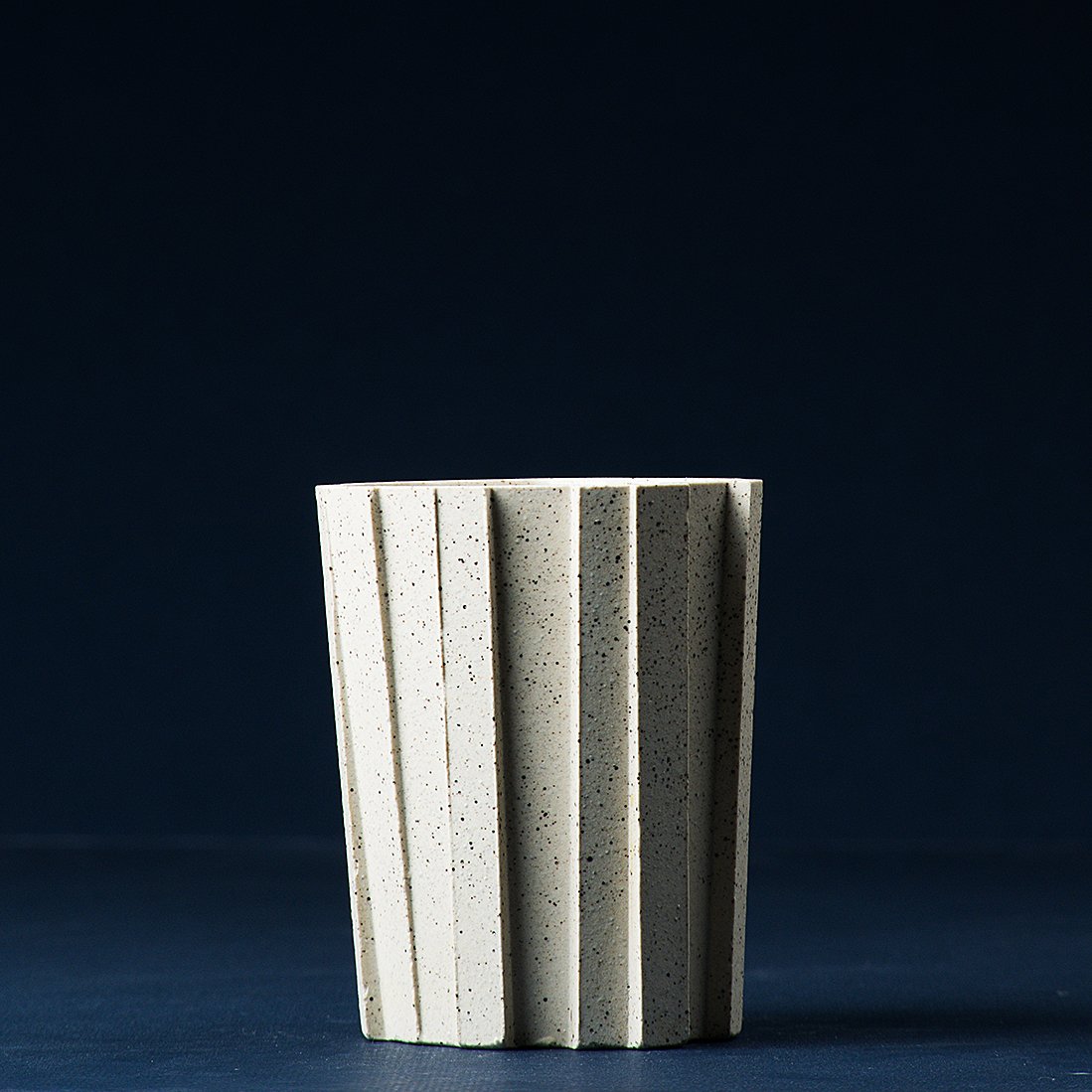 Handmade brutalist faceted ceramic tumbler, speckled white stoneware, by Lea & Nicolas