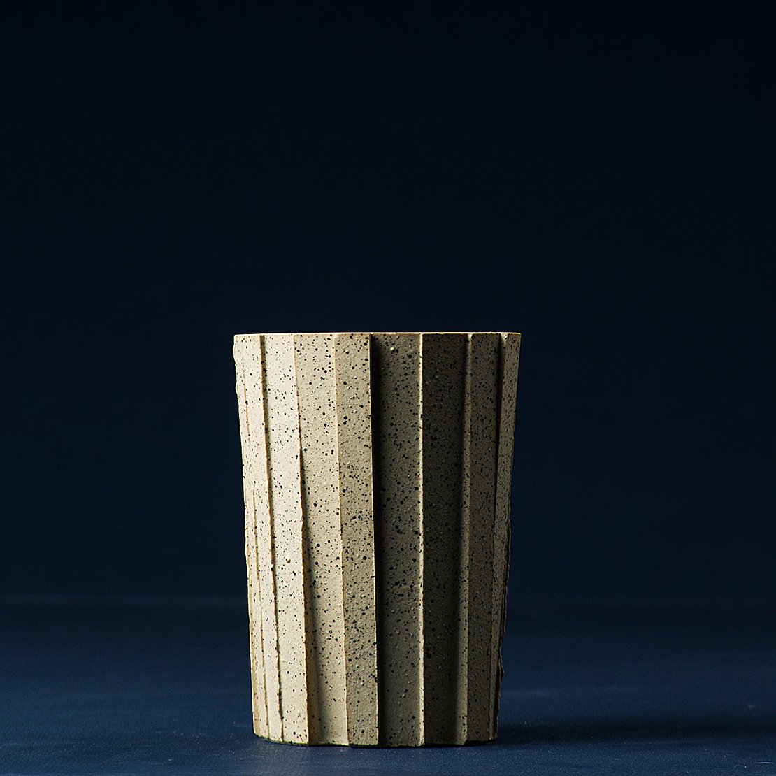 Brutalist handmade faceted ceramic tumbler in speckled buff stoneware, by Lea & Nicolas