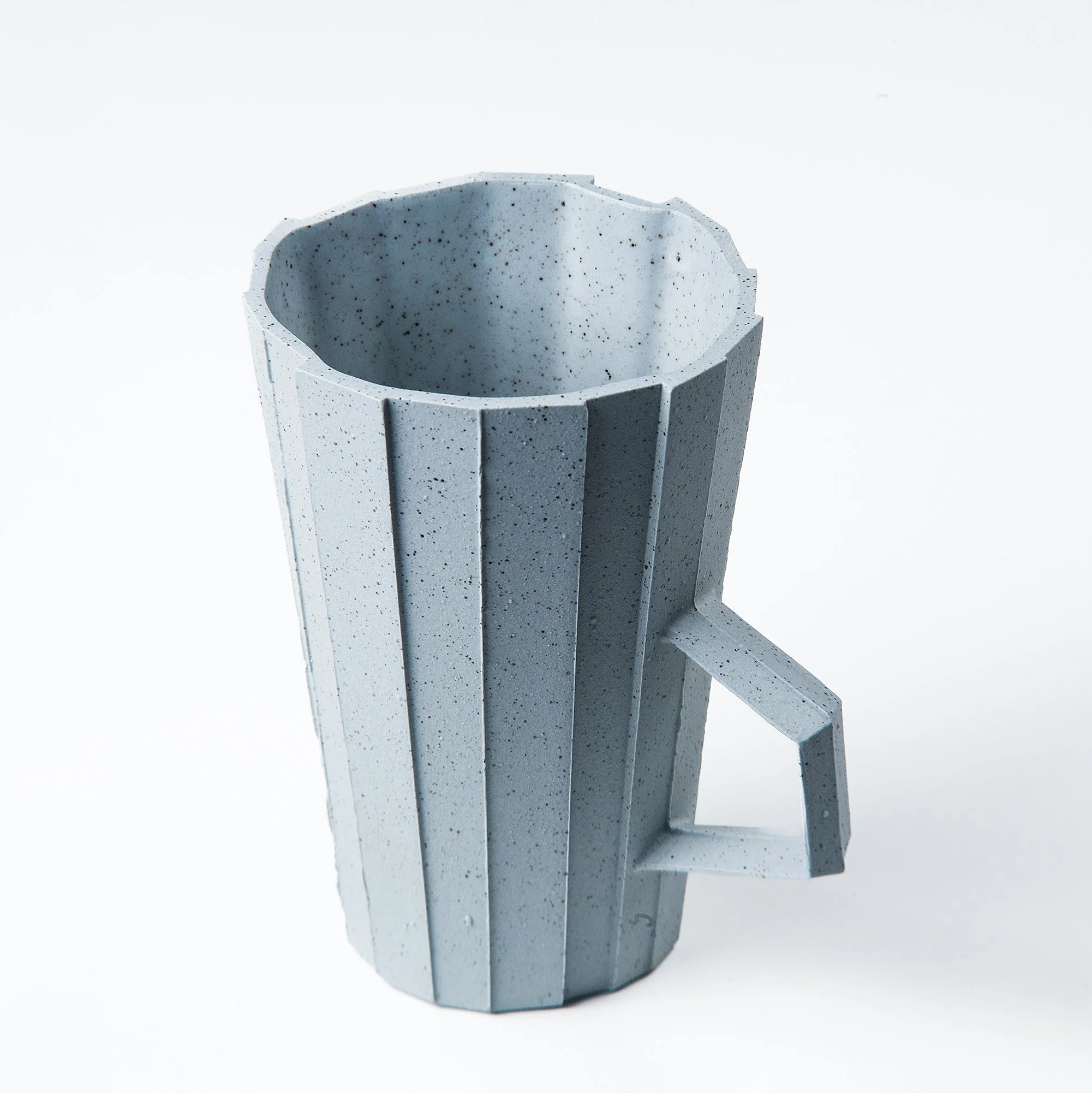 Handmade brutalist faceted ceramic cup in speckled blue stoneware, by Lea & Nicolas