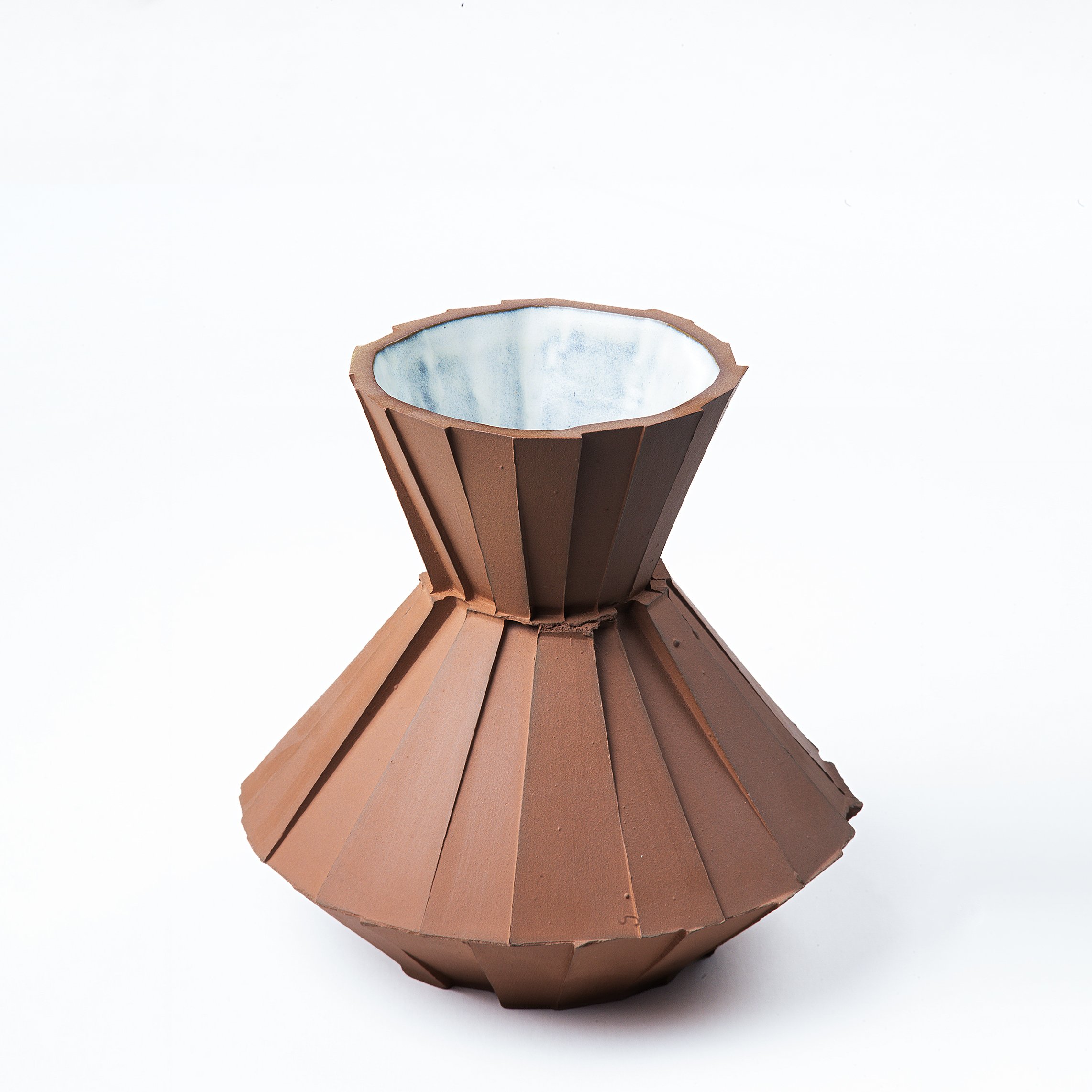 Handmade faceted ceramic carafe with unglazed red stoneware exterior and off-white glazed interior, by Lea & Nicolas