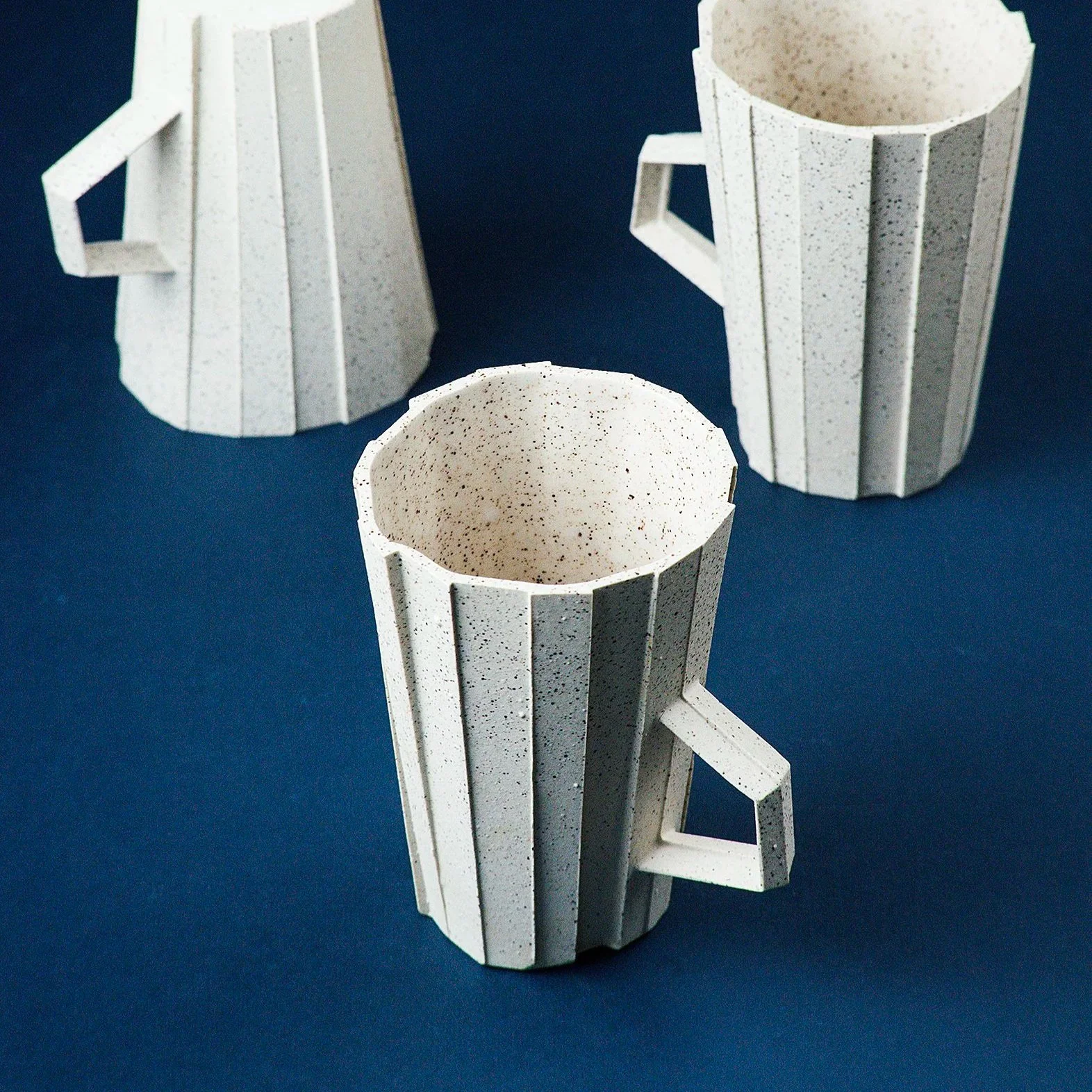 Handmade brutalist faceted ceramic cup in speckled white stoneware, by Lea & Nicolas
