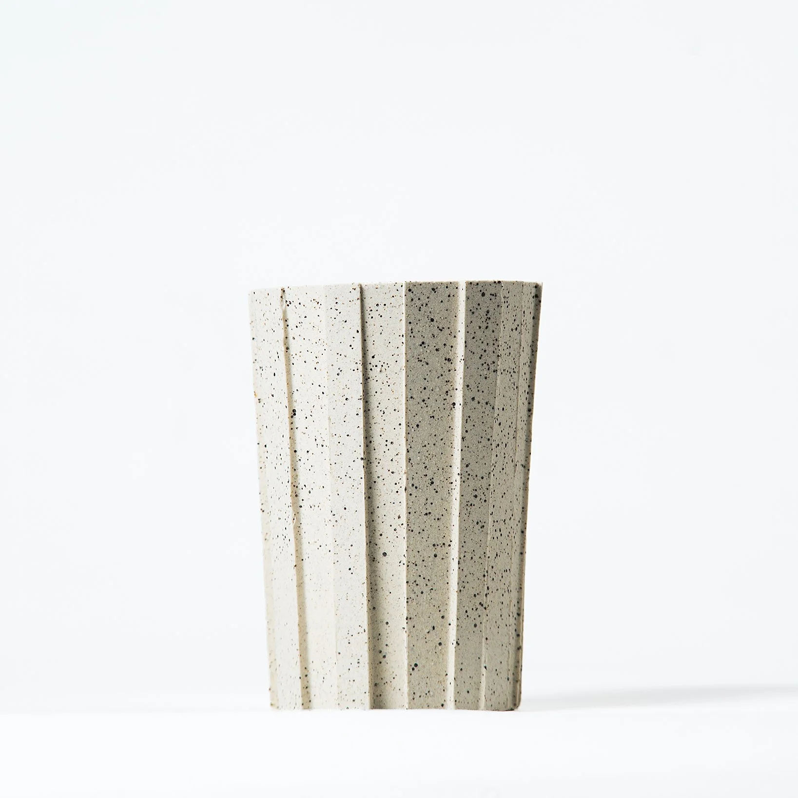 Handmade brutalist faceted ceramic tumbler, speckled white stoneware, by Lea & Nicolas