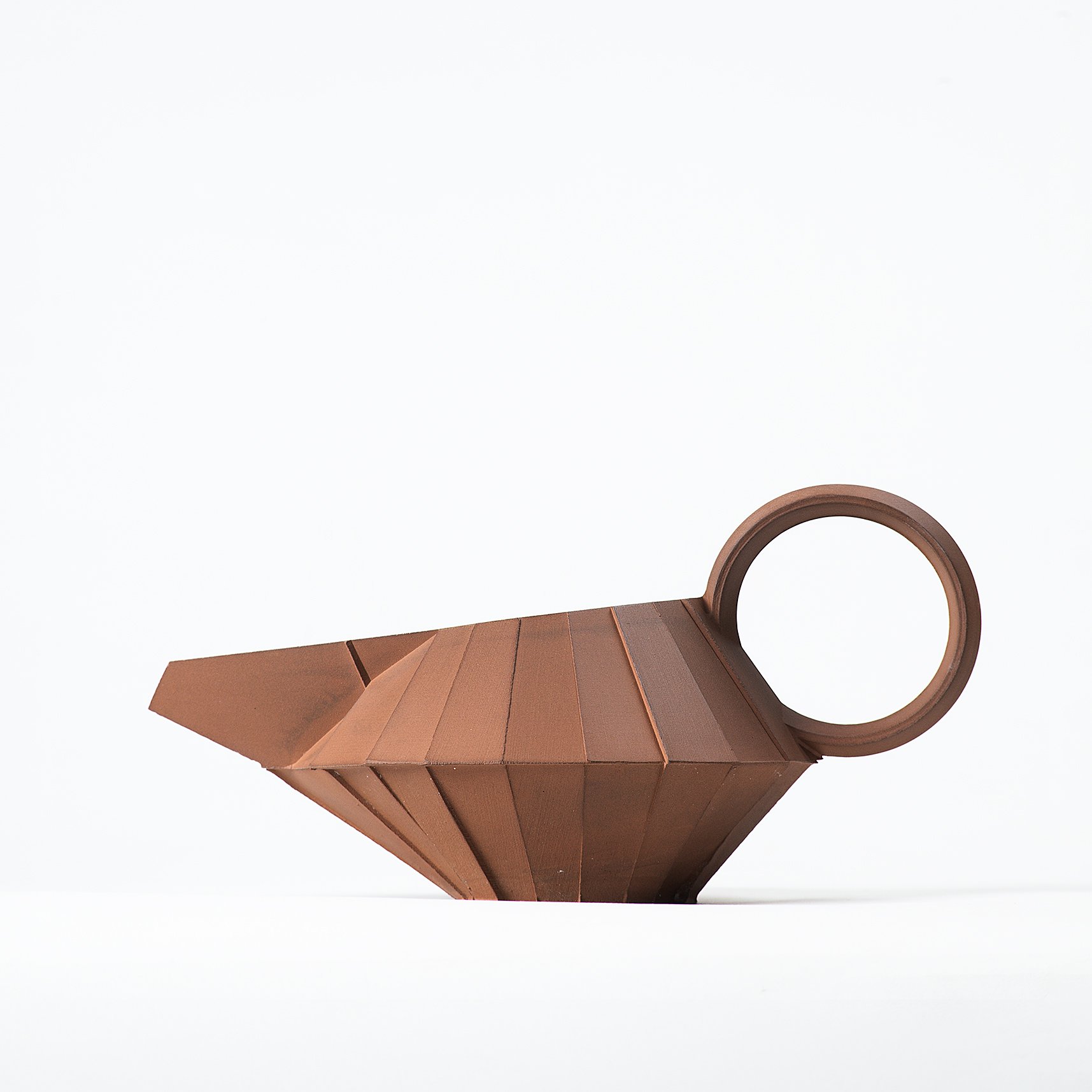 Handmade faceted ceramic gravy boat with unglazed red stoneware exterior and off-white glazed interior, by Lea & Nicolas
