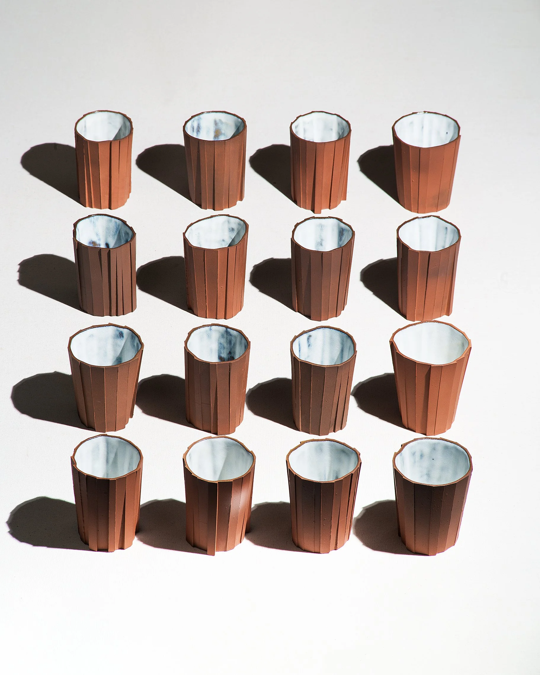 Handmade brutalist faceted ceramic tumbler, unglazed red stoneware, by Lea & Nicolas
