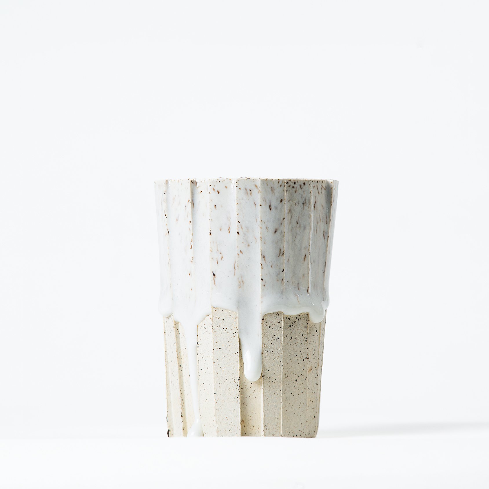 Handmade brutalist faceted ceramic tumbler, speckled white stoneware and drippy glaze, by Lea & Nicolas
