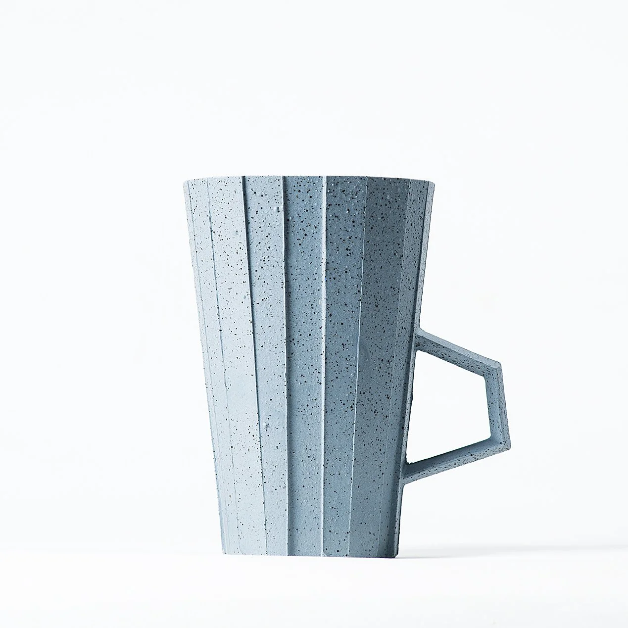 Handmade brutalist faceted ceramic cup in speckled blue stoneware, by Lea & Nicolas