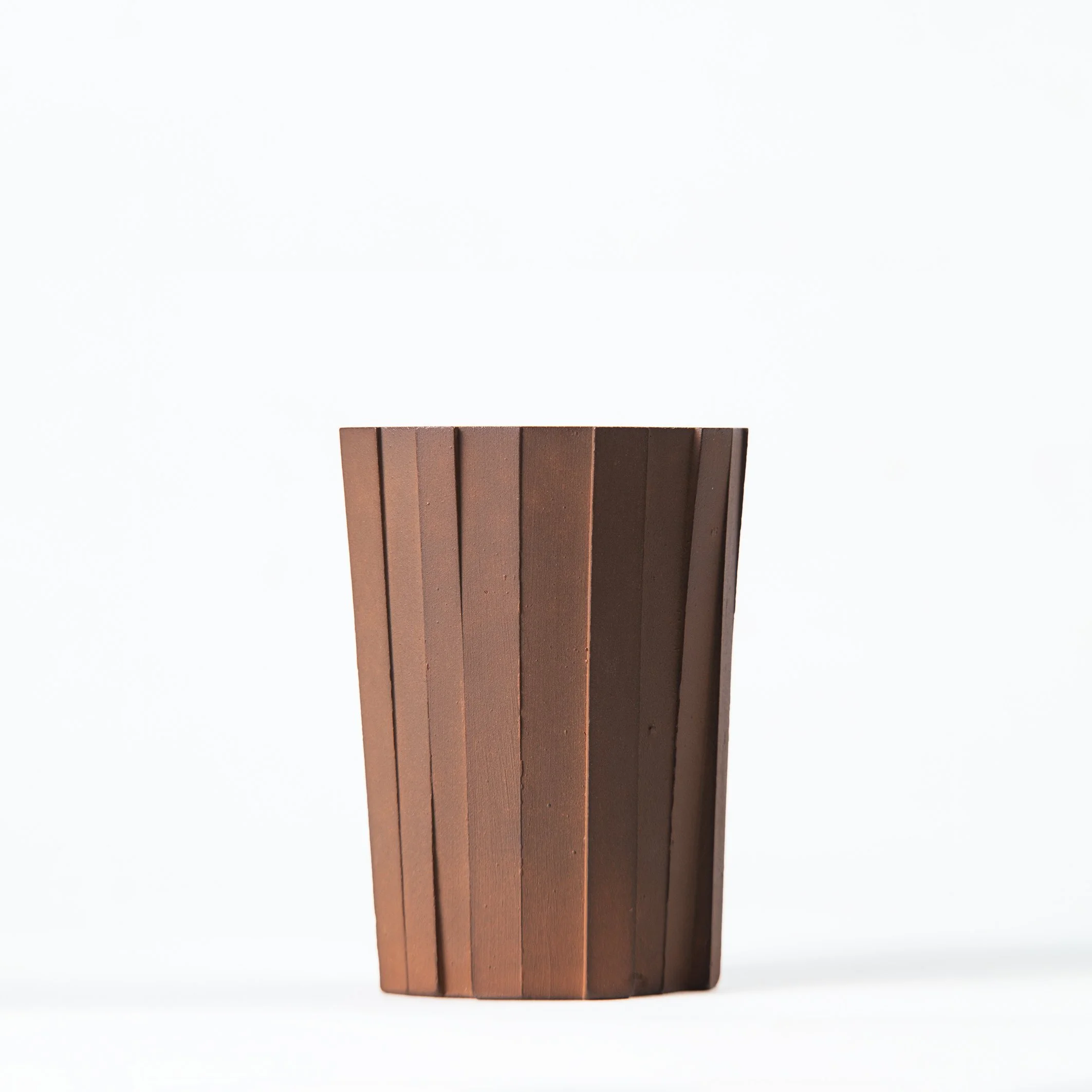 Handmade brutalist faceted ceramic tumbler, unglazed red stoneware, by Lea & Nicolas