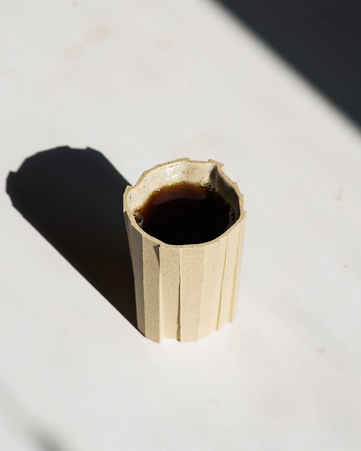 Handmade brutalist faceted ceramic tumbler, speckled yellow stoneware, by Lea & Nicolas