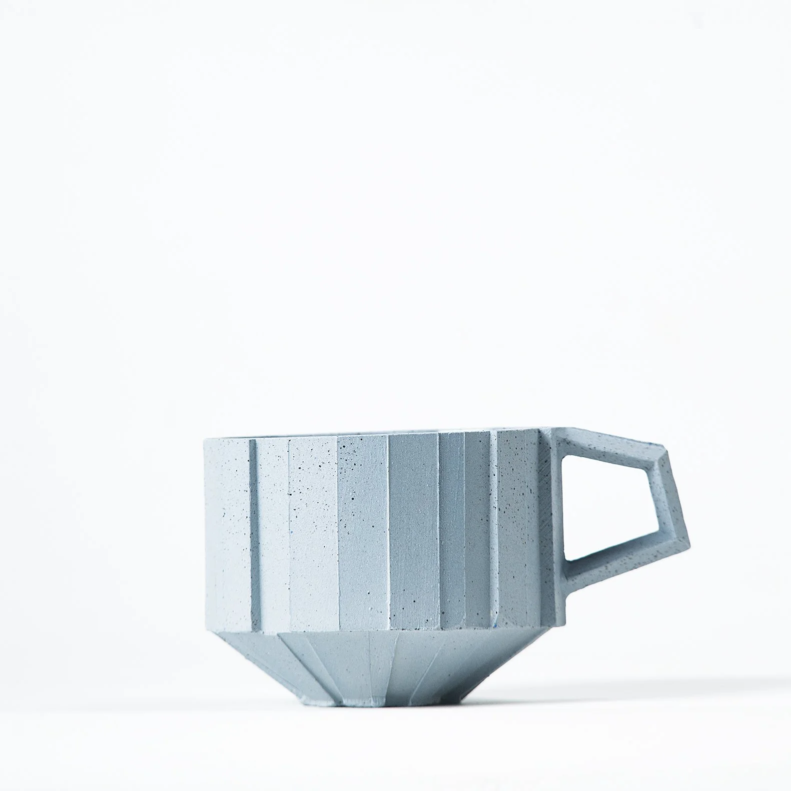 Handmade brutalist faceted ceramic cup in speckled blue stoneware, by Lea & Nicolas