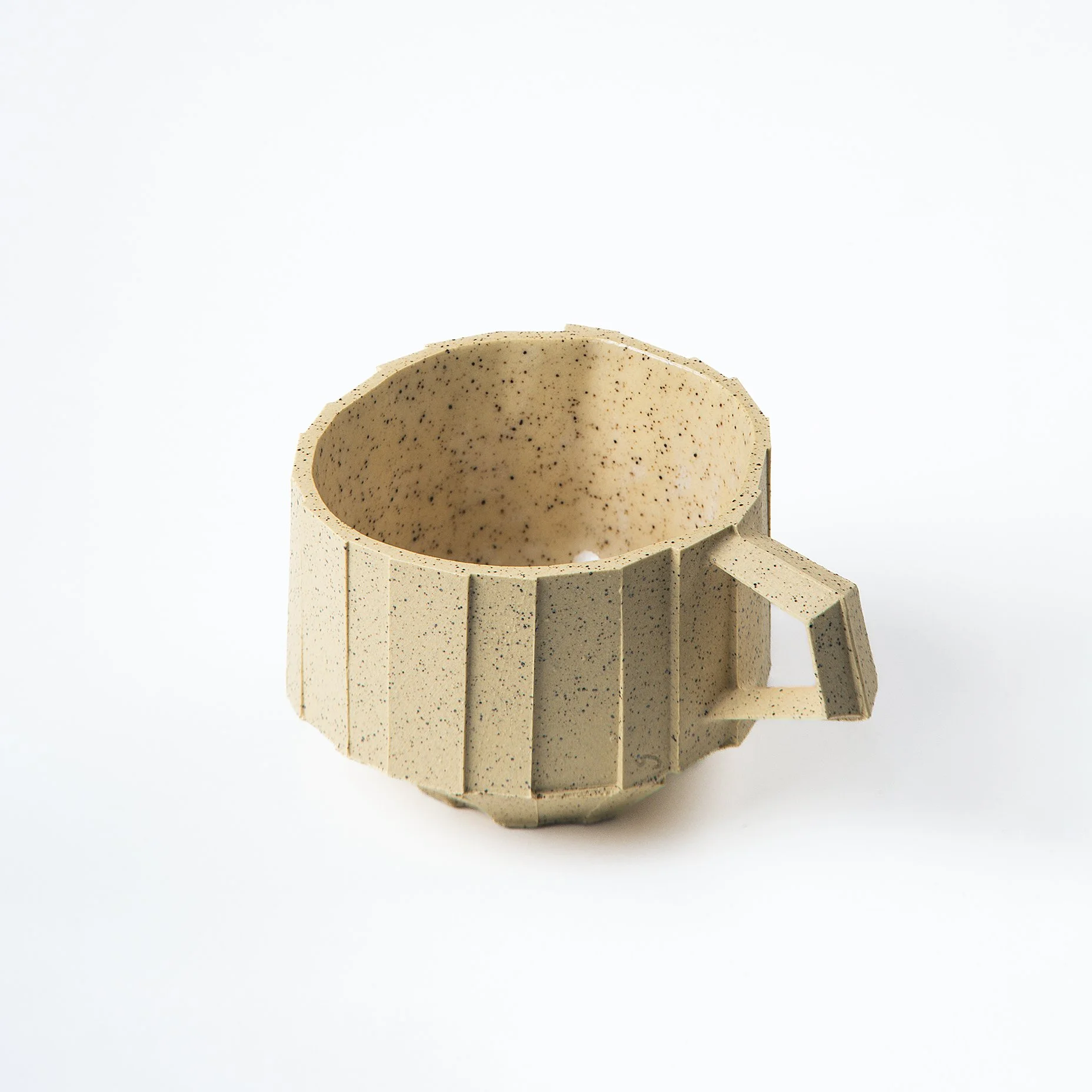 Handmade brutalist faceted ceramic cup in speckled yellow stoneware, by Lea & Nicolas